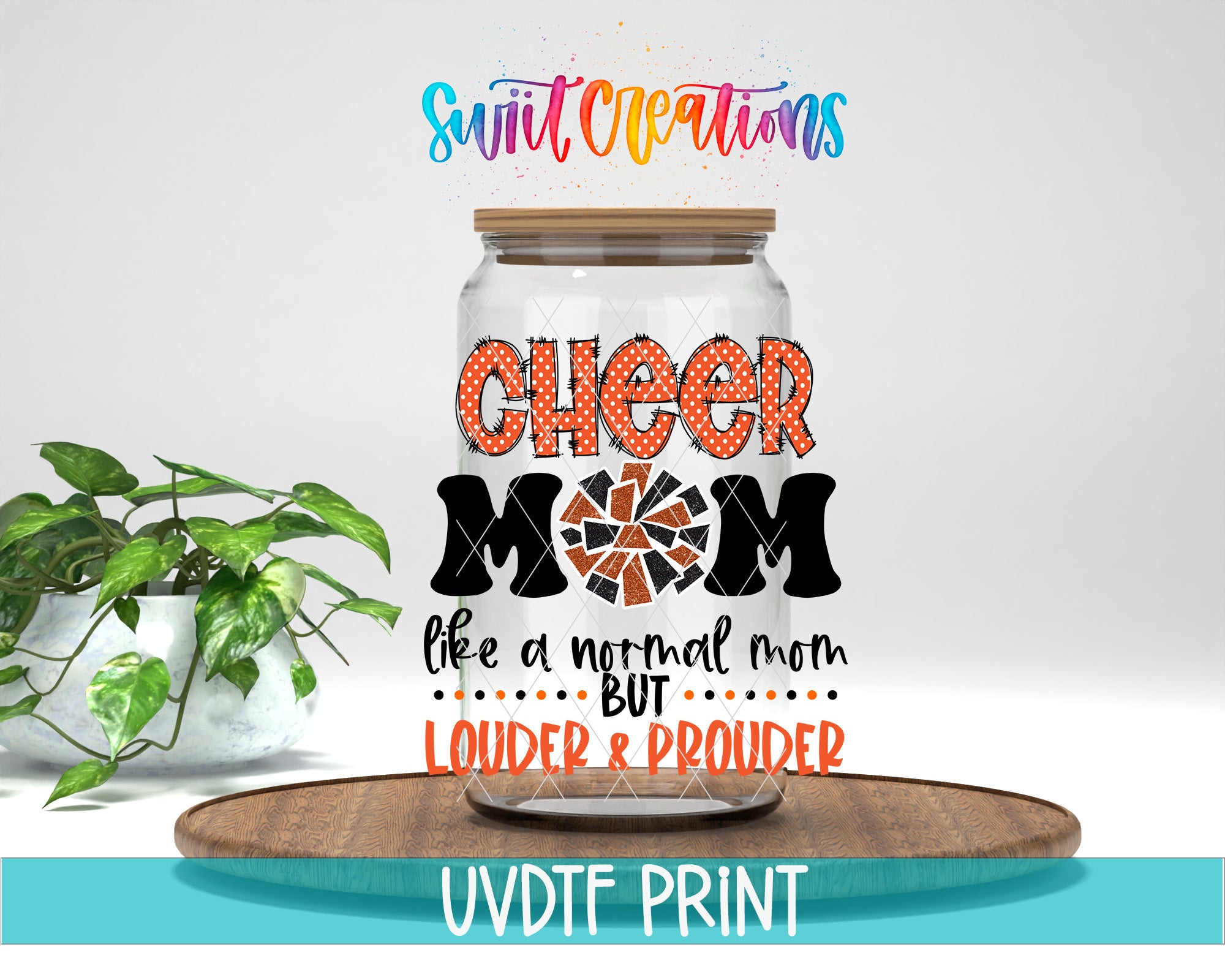 a glass jar with a label that says "CHEER MOM LIKE A NORMAL MOM BUT LOUDER & PROUDER" in a colorful, artistic style. The jar is placed on a wooden surface, and there is a potted plant in the background.