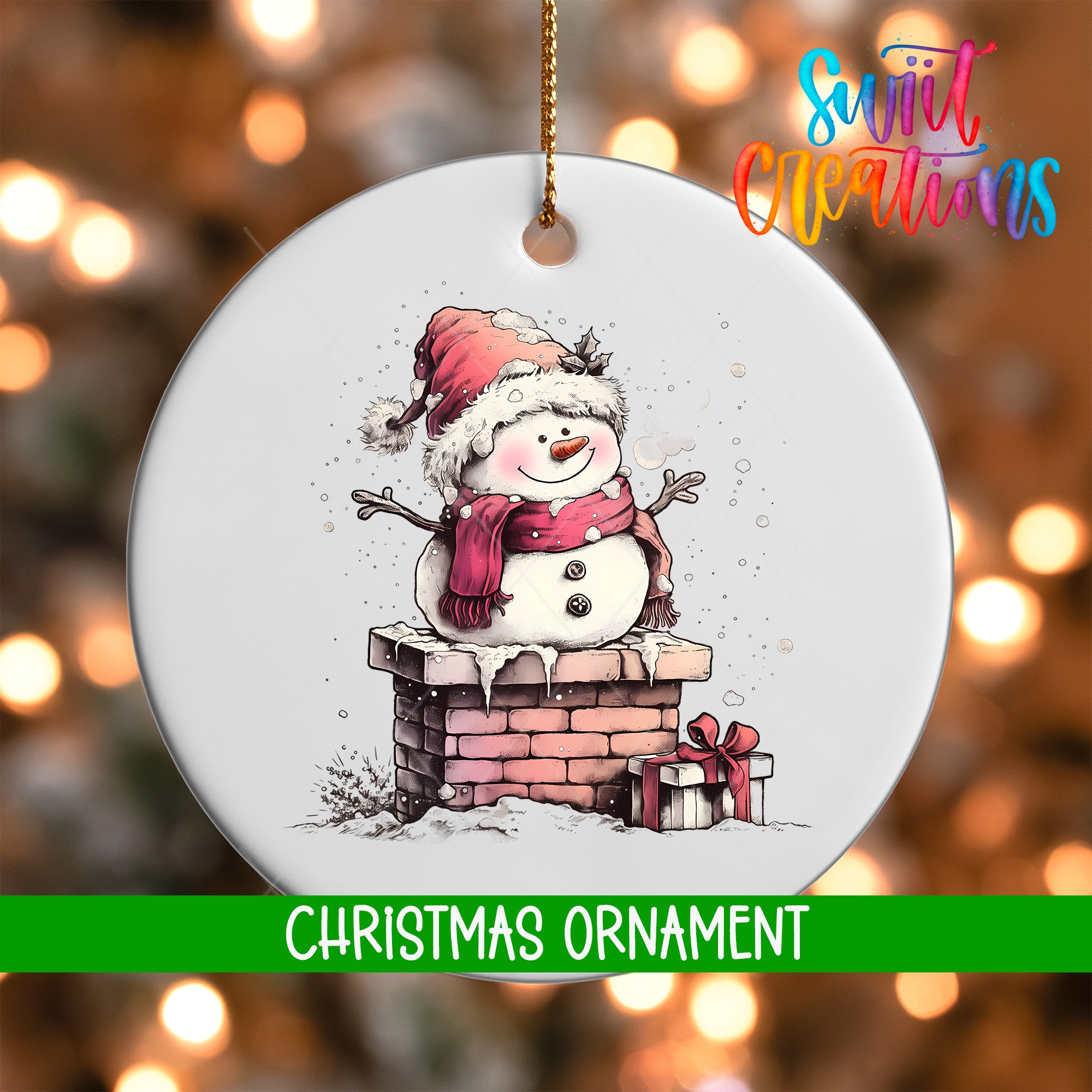 A white Christmas ornament featuring a snowman on a brick chimney, with a gift box and a red bow on the ground below.