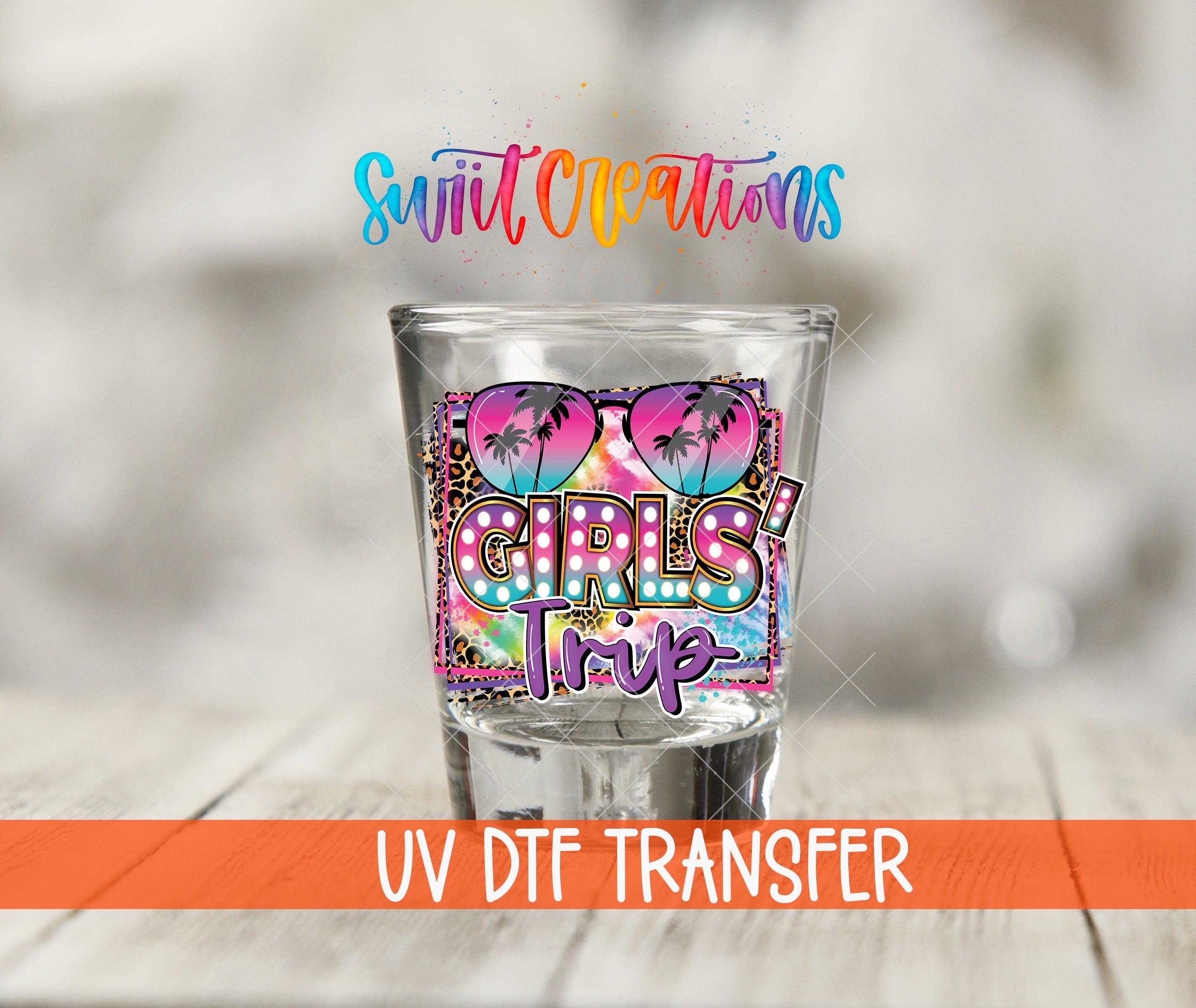 A glass with a colorful design featuring sunglasses and palm trees, along with the text "GIRLS TRIP" printed on it.