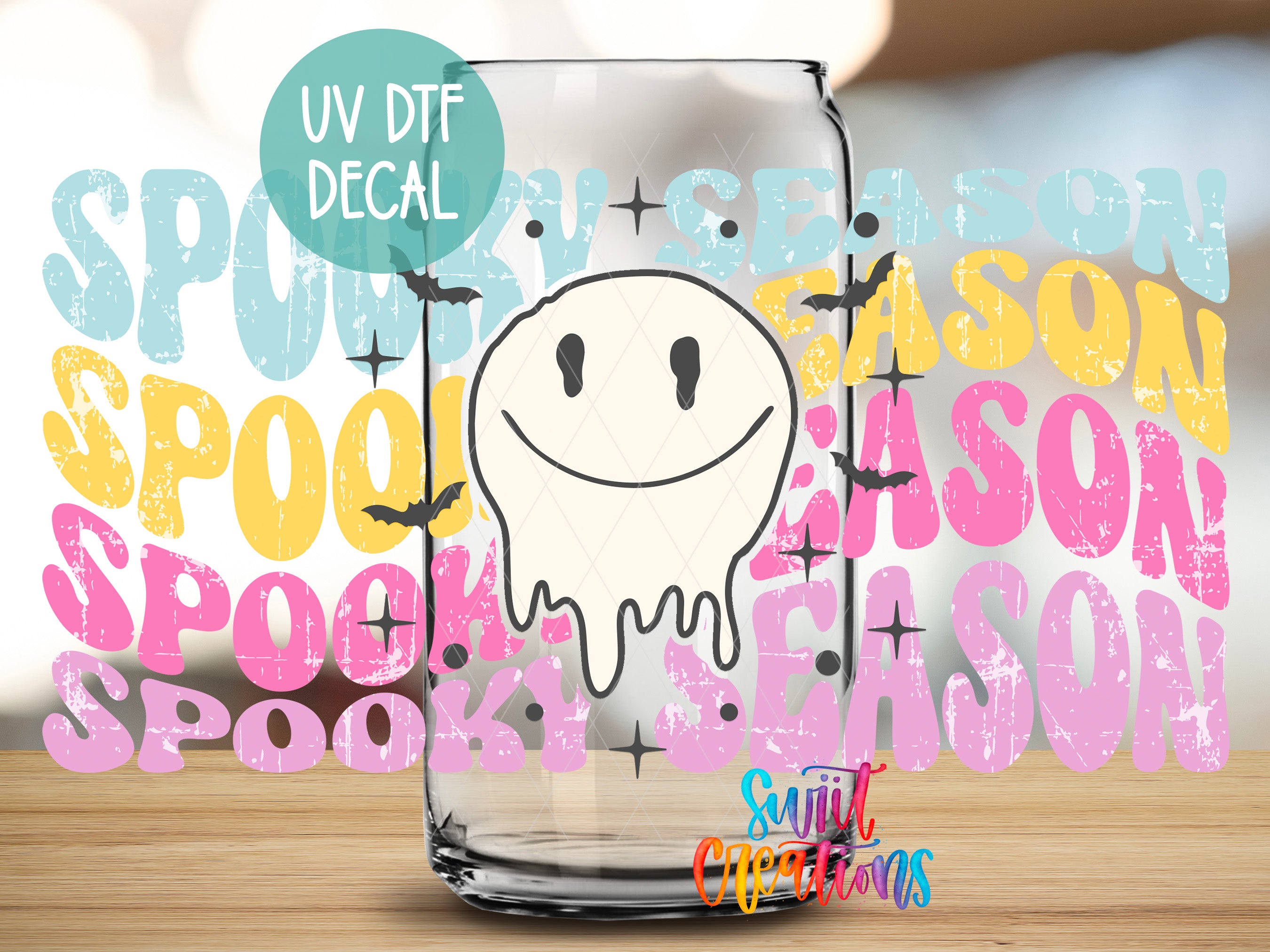 a Halloween-themed decal of a ghost with a smiley face, placed on a glass surface. The background is filled with various Halloween-related text and graphics, including the words "SPOOKY SEASON" and "SPOOKY".