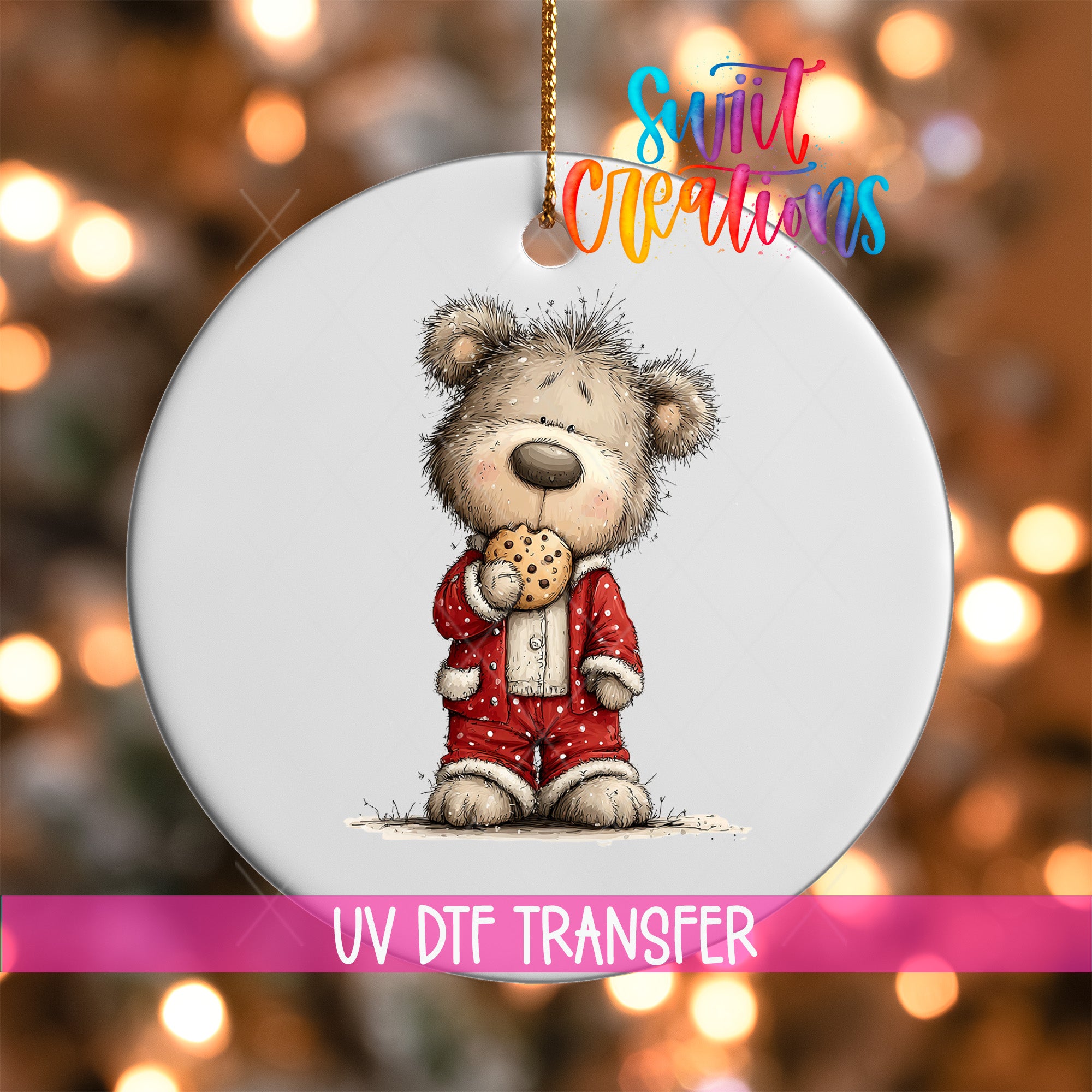 A white ornament featuring a cartoon teddy bear wearing a red outfit and holding a cookie.