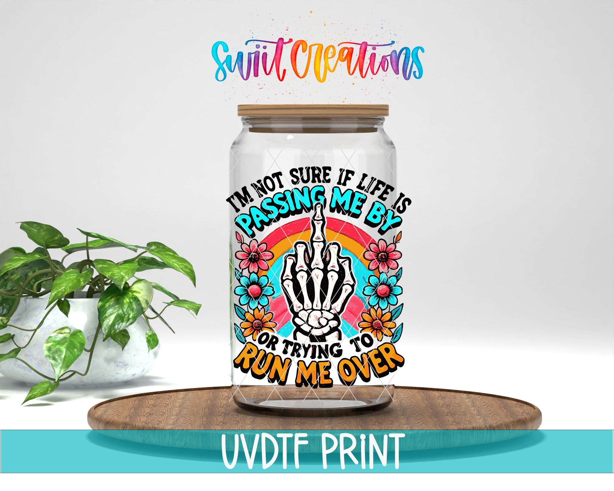 a glass jar with a colorful and artistic design, including a skeleton hand, flowers, and a rainbow. The text on the jar reads "I'm not sure if life is passing me by, or trying to run me over".
