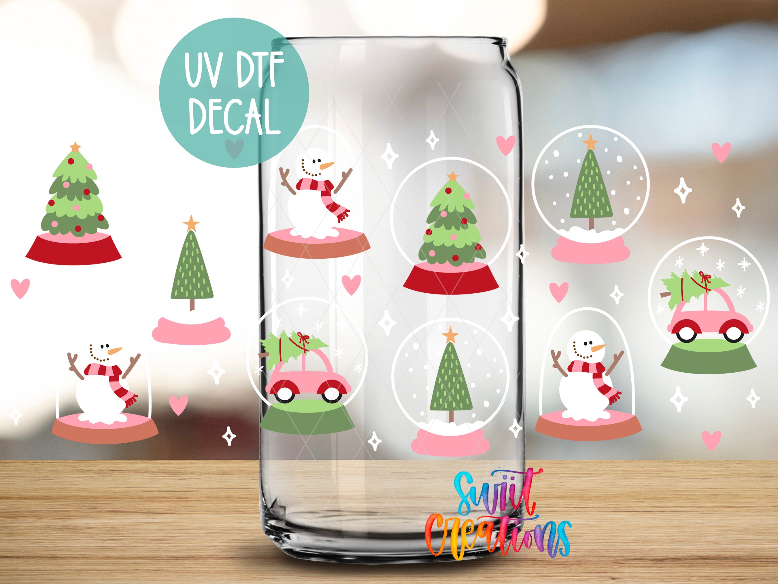 a glass with a snowman and a christmas tree inside of it