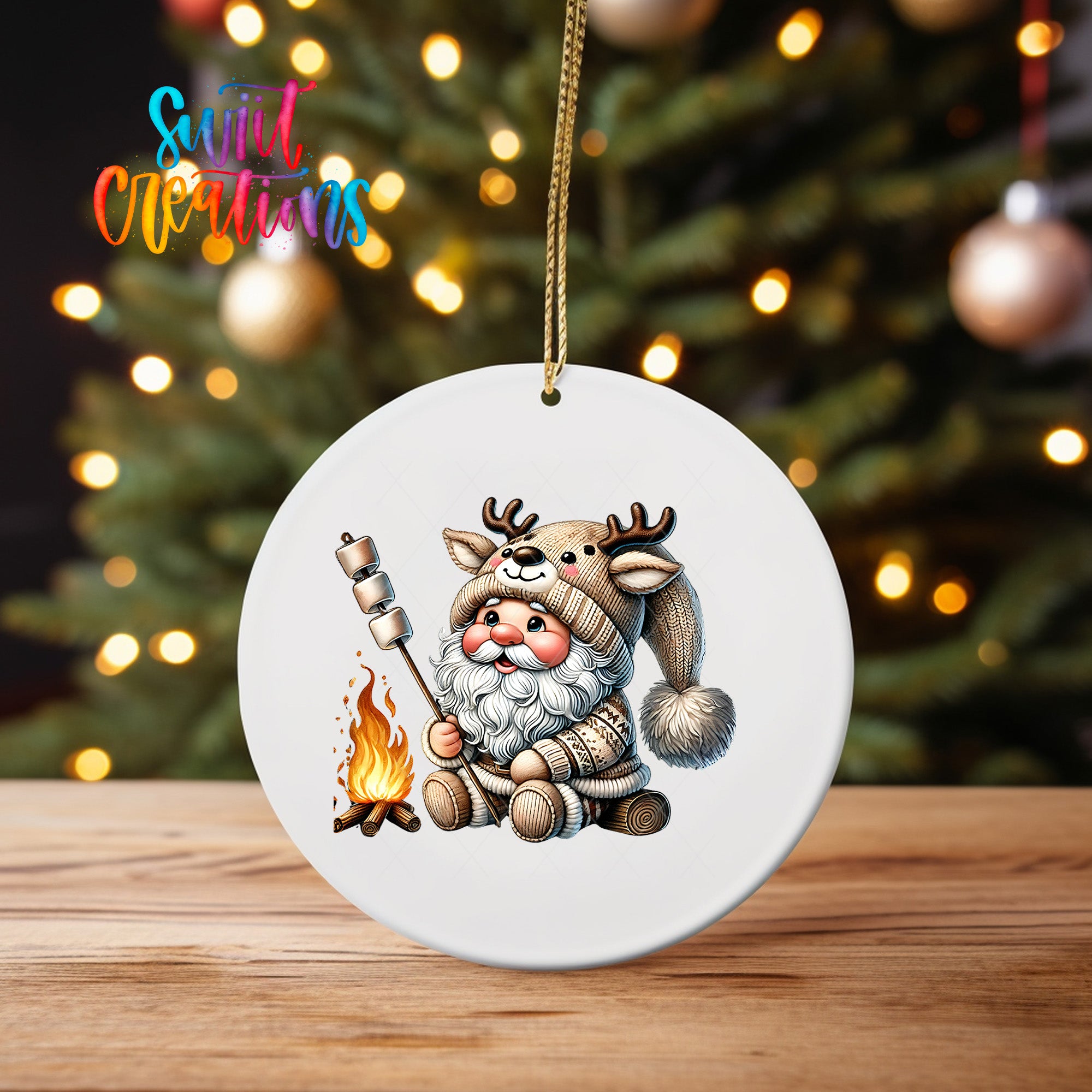 A white ceramic ornament featuring a cartoon image of Santa Claus holding a marshmallow over a campfire, with a background of a blurred Christmas tree.