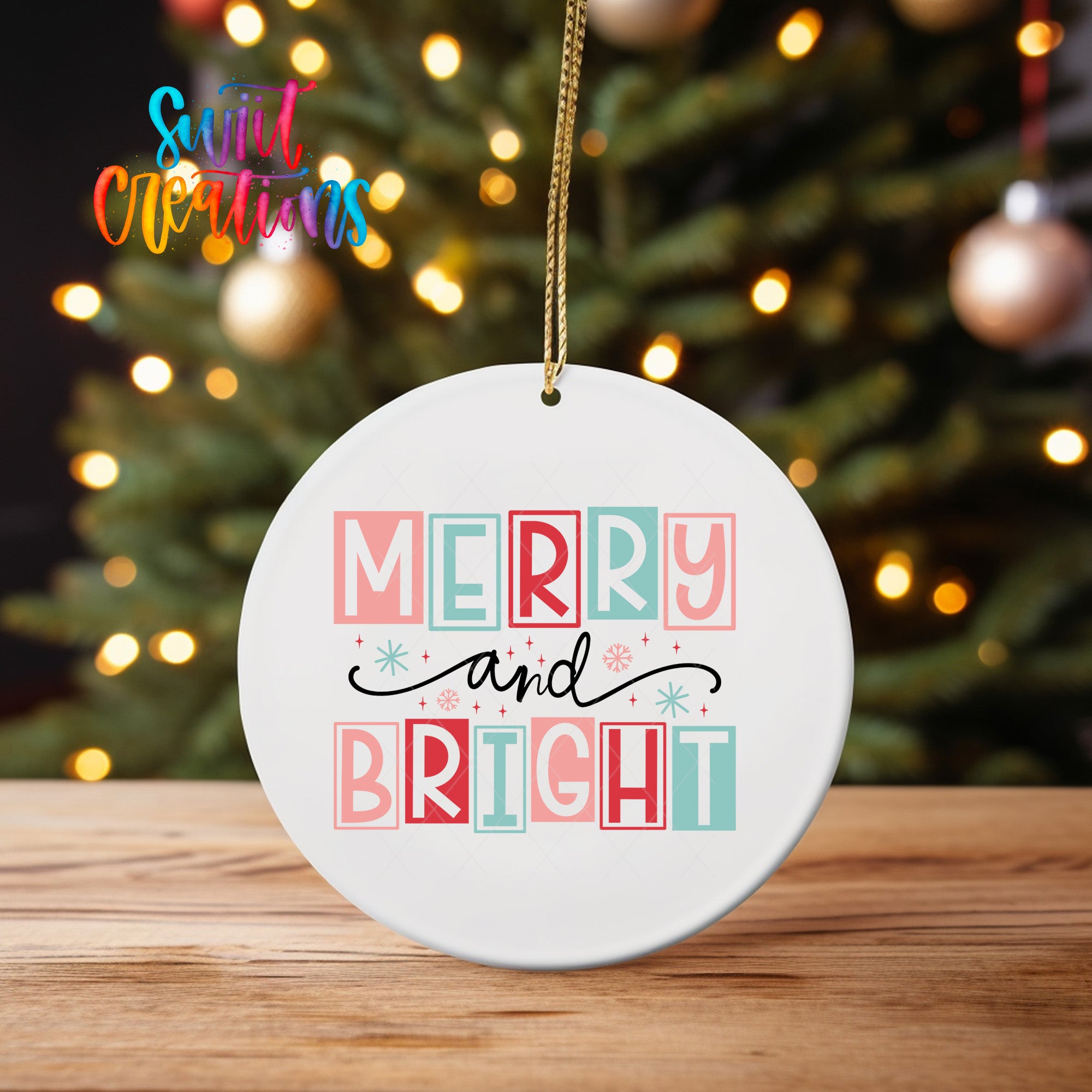 A white ceramic ornament with the text "MERRY AND BRIGHT" printed on it, hanging from a string.