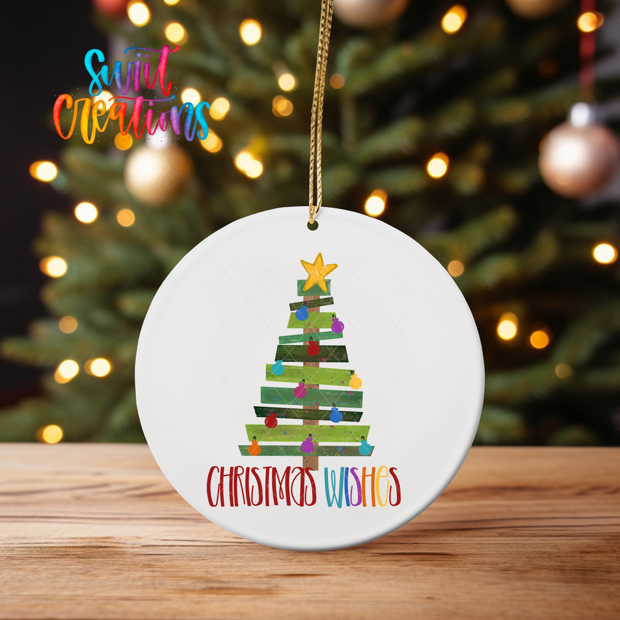 A white Christmas tree ornament with a star and colorful ornaments, hanging on a string.