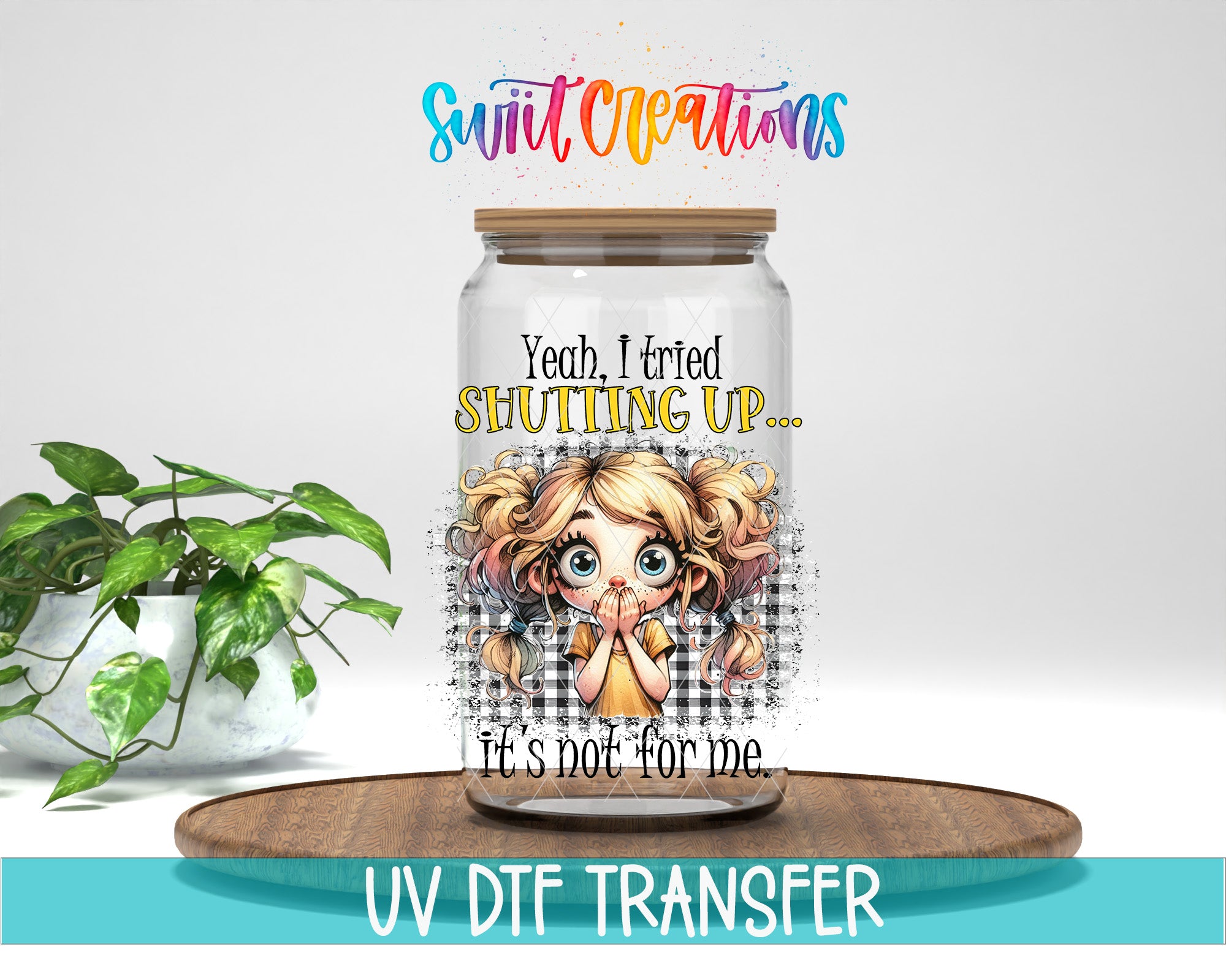 a glass jar with a cartoon girl on it, placed on a wooden tray. The jar has a lid and a label with text and an illustration. The background of the image is white, and there is a plant visible in the background.