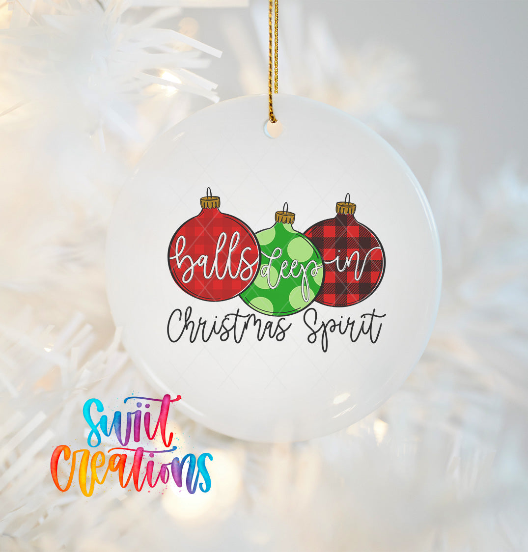 A white ornament with a Christmas tree design, featuring three colorful Christmas ornaments with the text "balls keep in Christmas spirit" written on it.