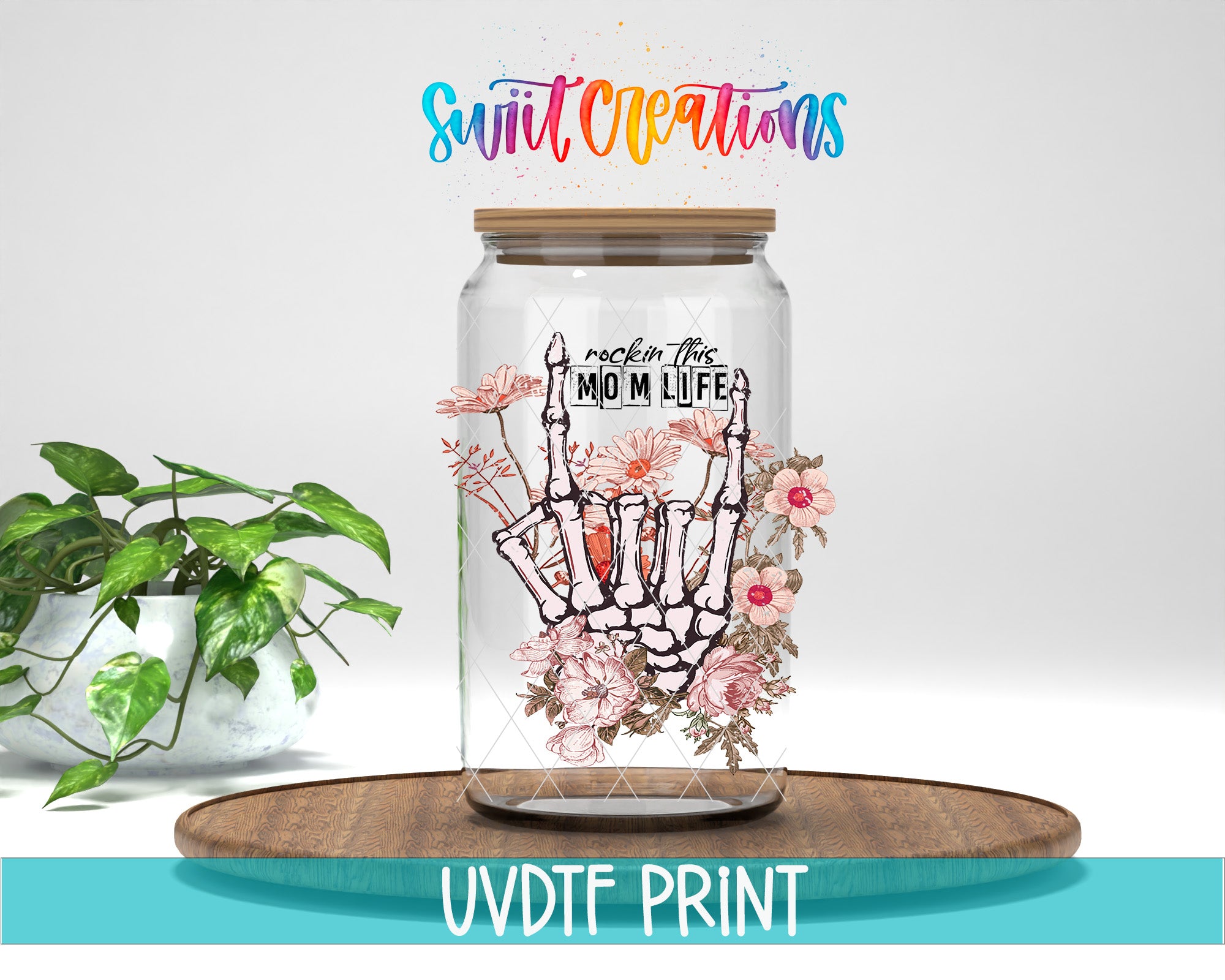 a glass jar filled with flowers on top of a wooden table