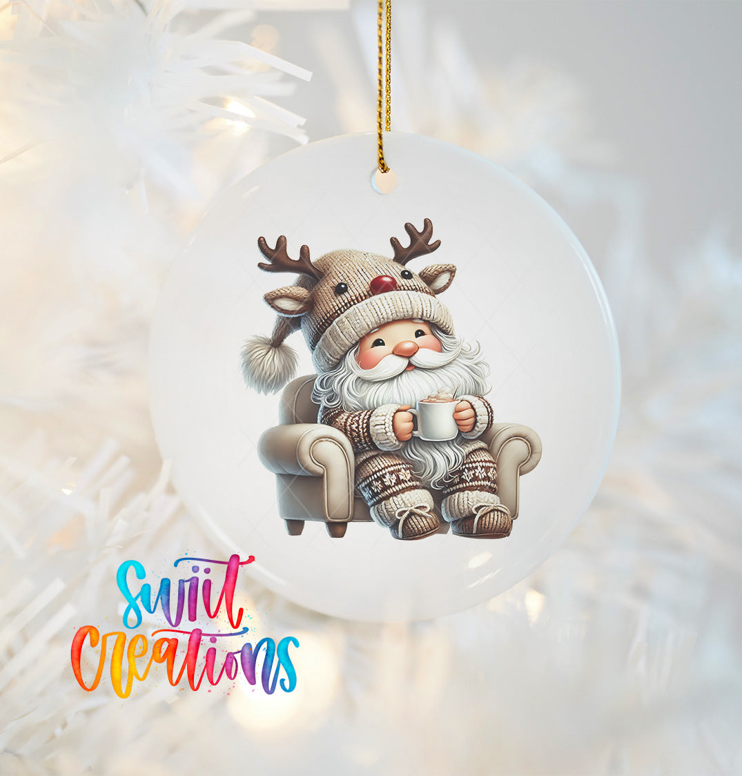 A white ornament featuring a cartoon reindeer wearing a Santa hat and holding a mug, sitting on a couch.