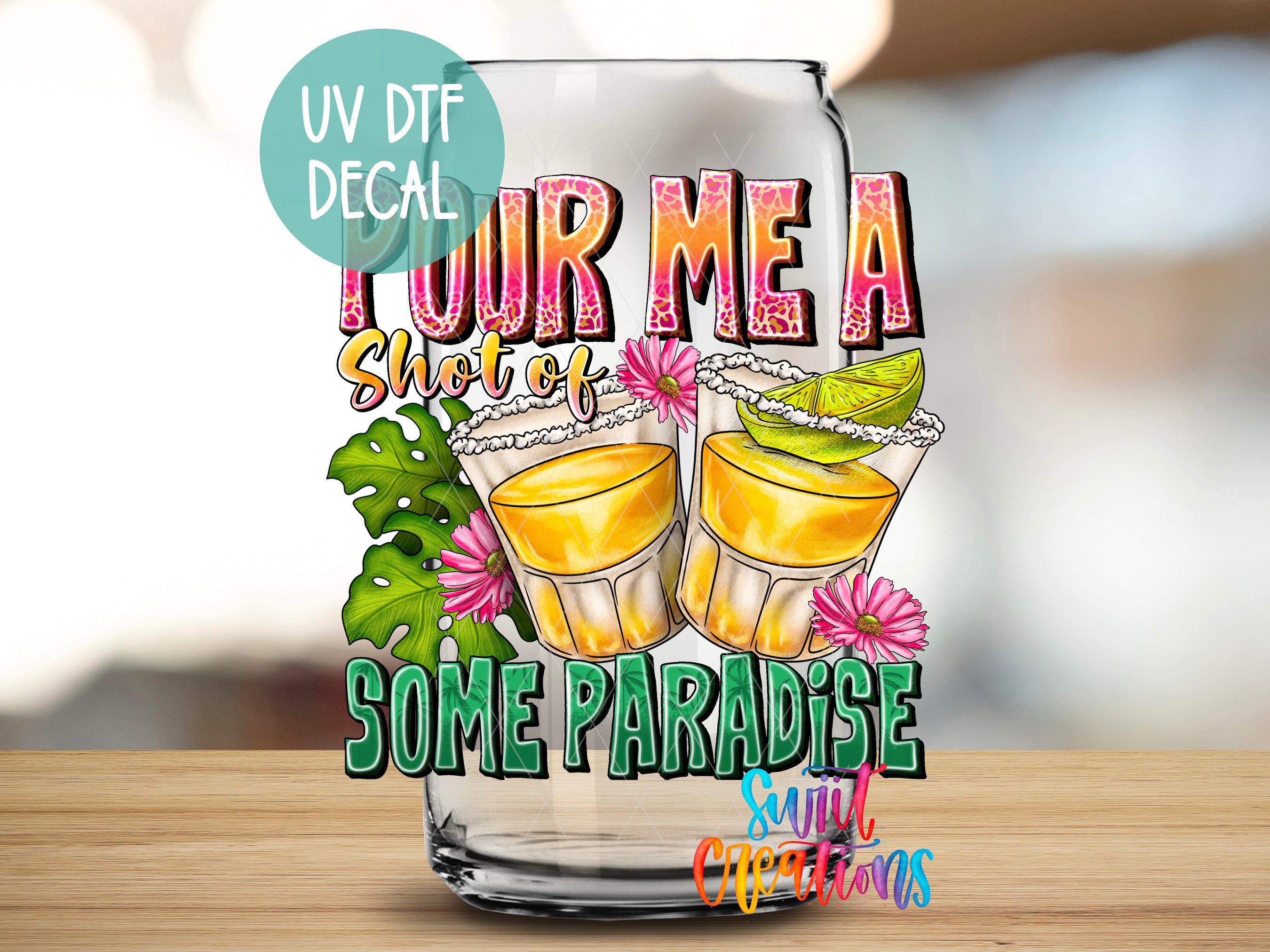 a glass with some drinks in it on a table