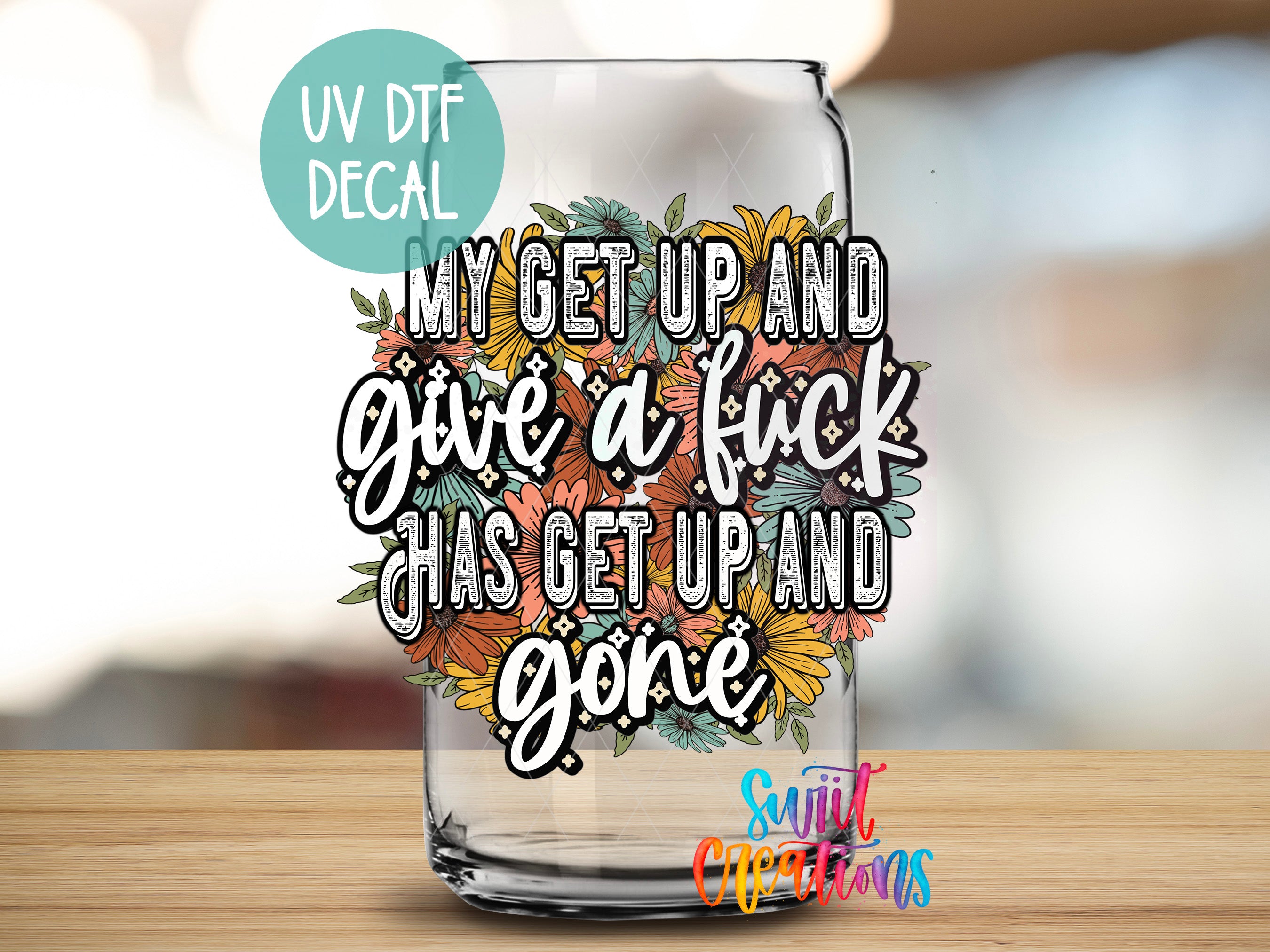 a glass with a quote on it sitting on a table