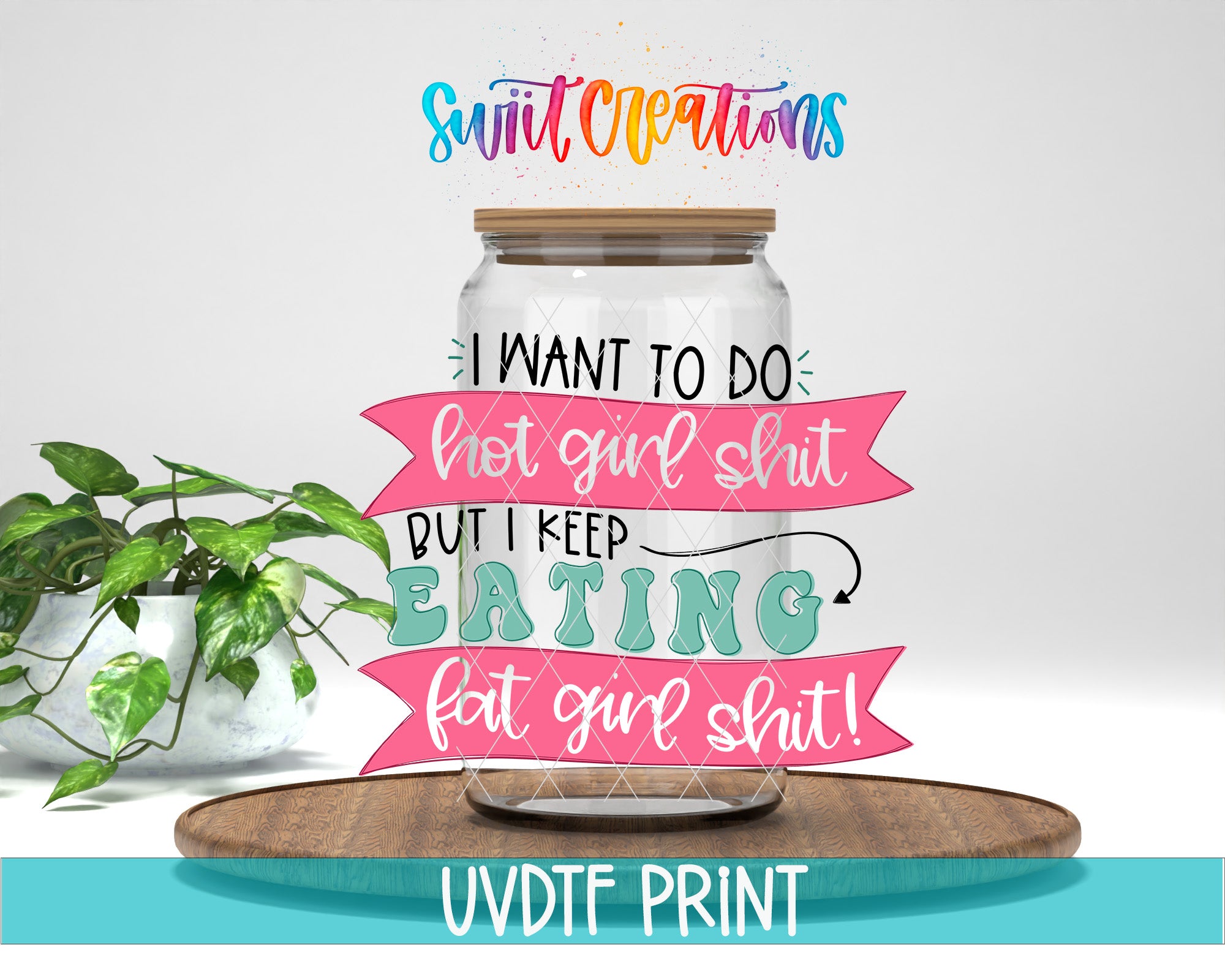 a glass jar with a handwritten message inside, placed on a wooden surface. The message reads "I WANT TO DO: hot girl shit but I KEEP EATING fat girl shit!" The jar is surrounded by colorful banners, and there is a potted plant in the background.