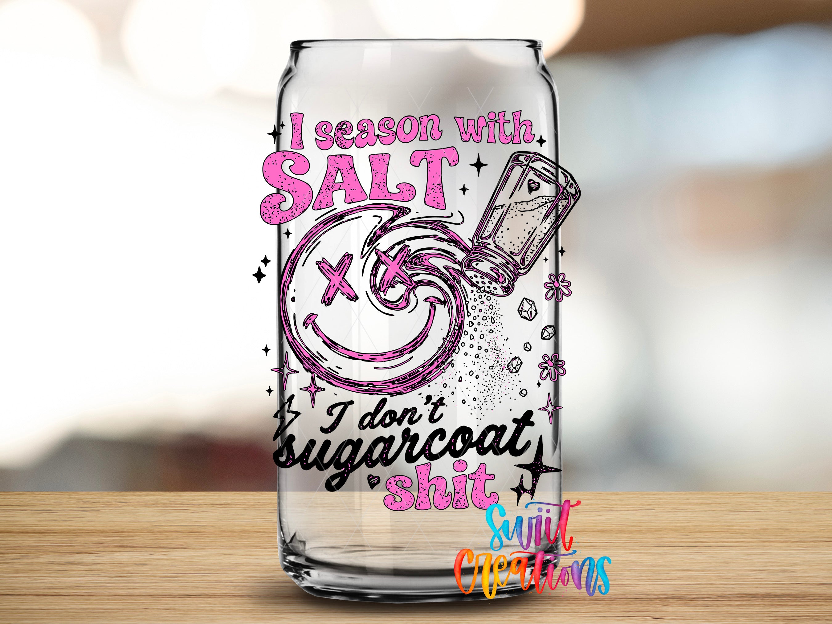 A glass can with a printed design on it, featuring a smiley face and text that says "I season with salt, I don't sugarcoat it, I don't sugarcoat shit".