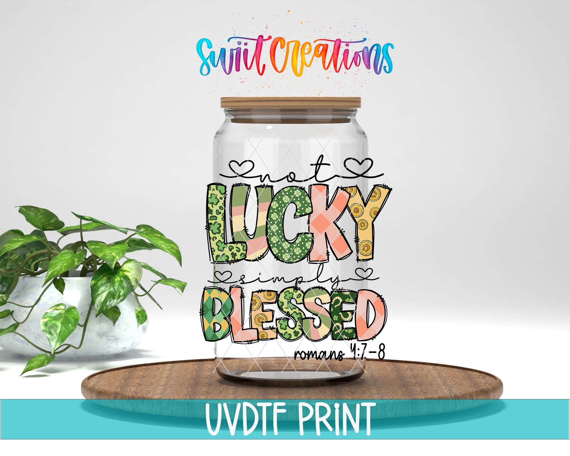 a glass jar with a colorful, hand-drawn design on it, placed on a wooden surface. The jar has a lid and is surrounded by a potted plant. The text on the jar reads "not LUCKY, simply BLESSED" and "romans 4:7-8".