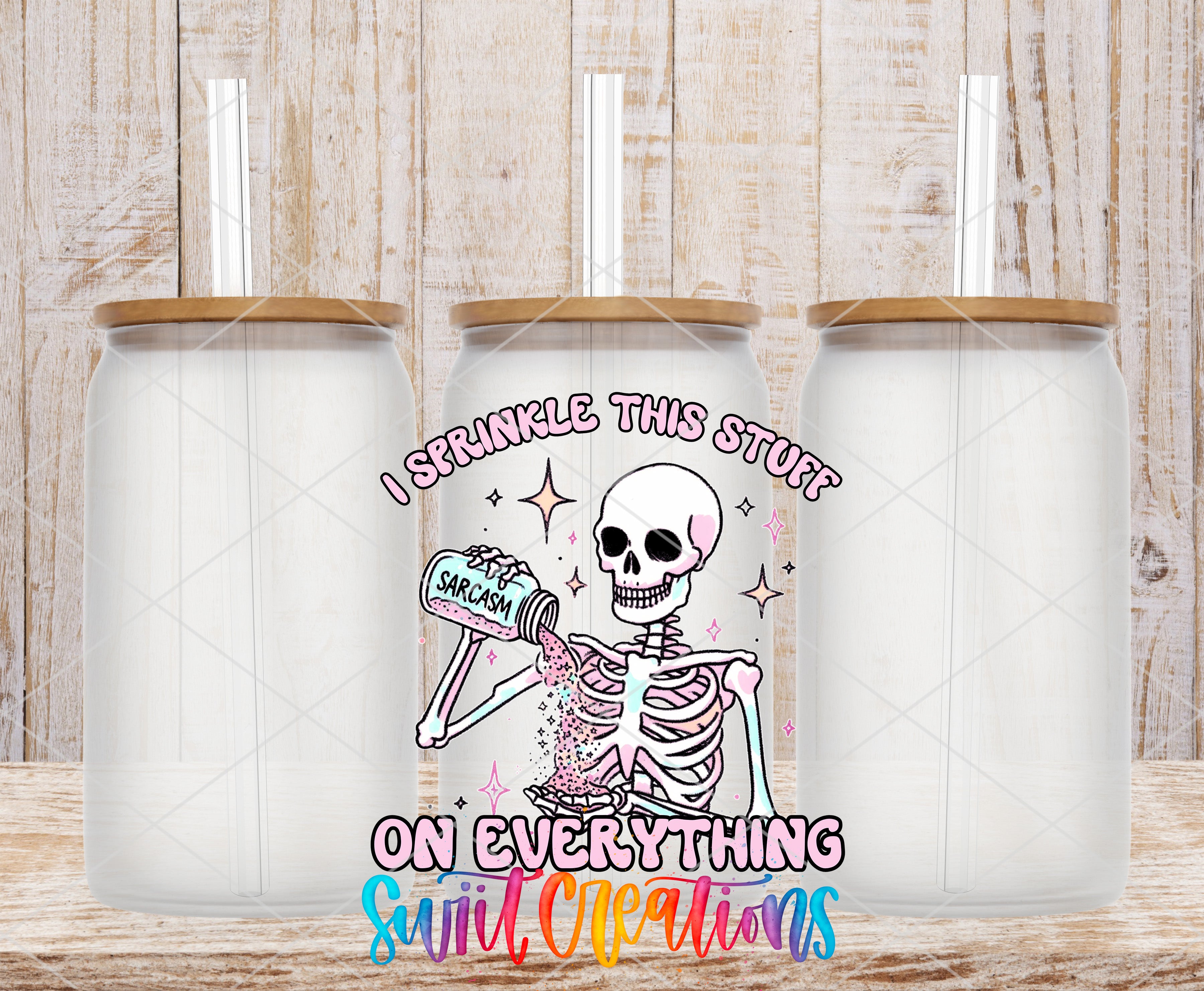 Swiit Creations UV DTF Sarcasm Skeleton transfer shown on a clear glass can set