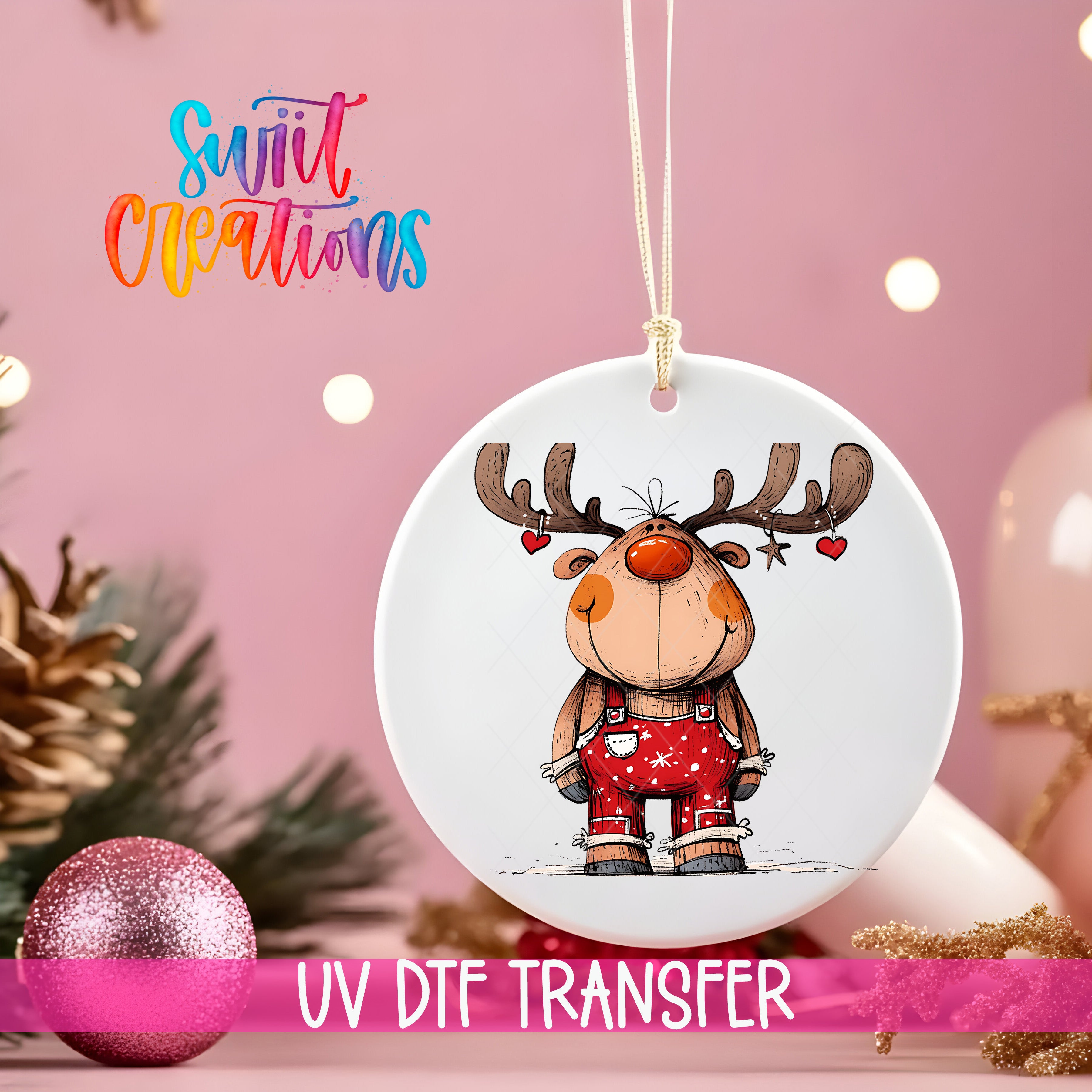 A white ornament with a cartoon reindeer design hangs against a pink background, with Christmas decorations and a pink glitter ball in the foreground.