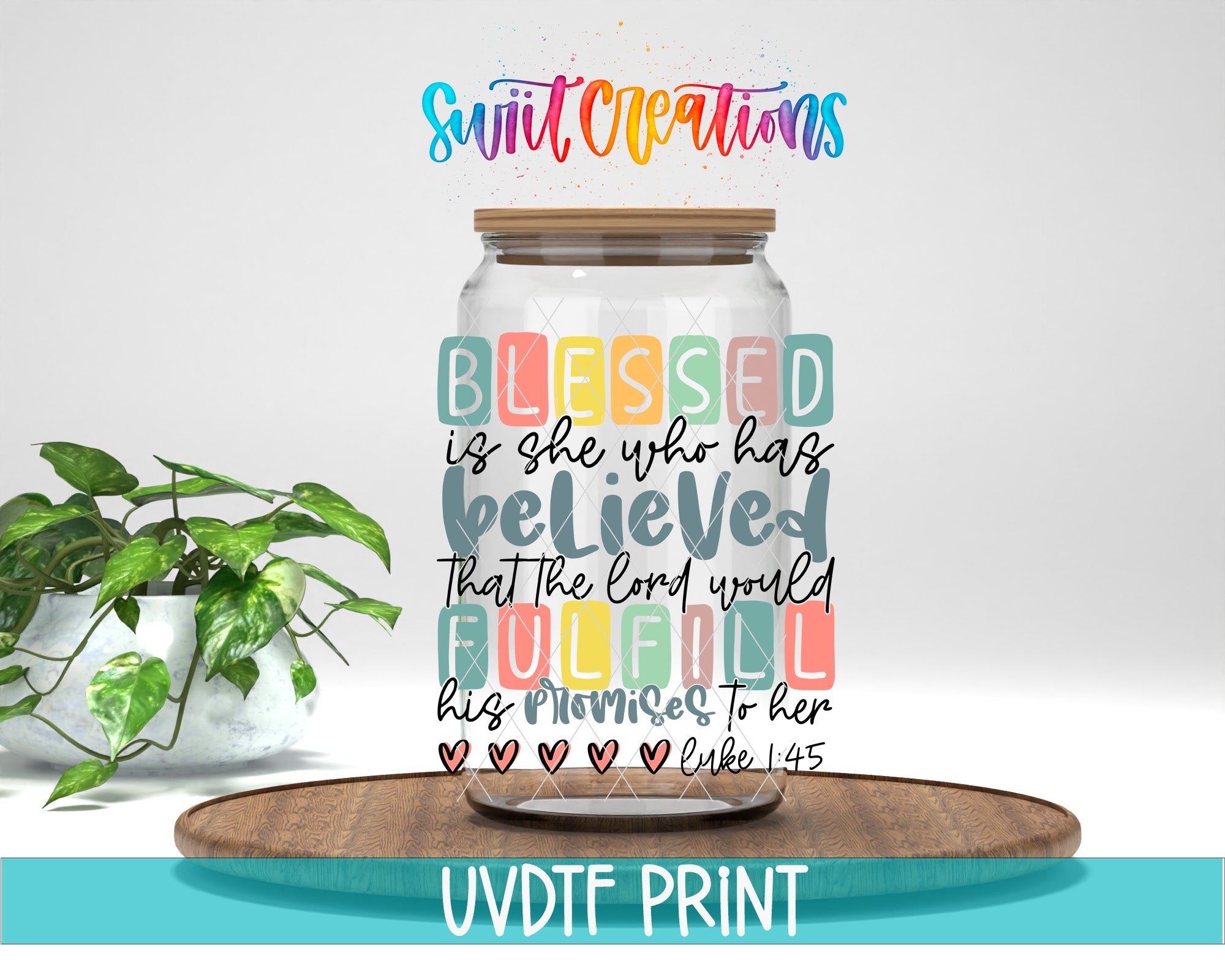 a glass jar with a quote on it sitting next to a potted plant
