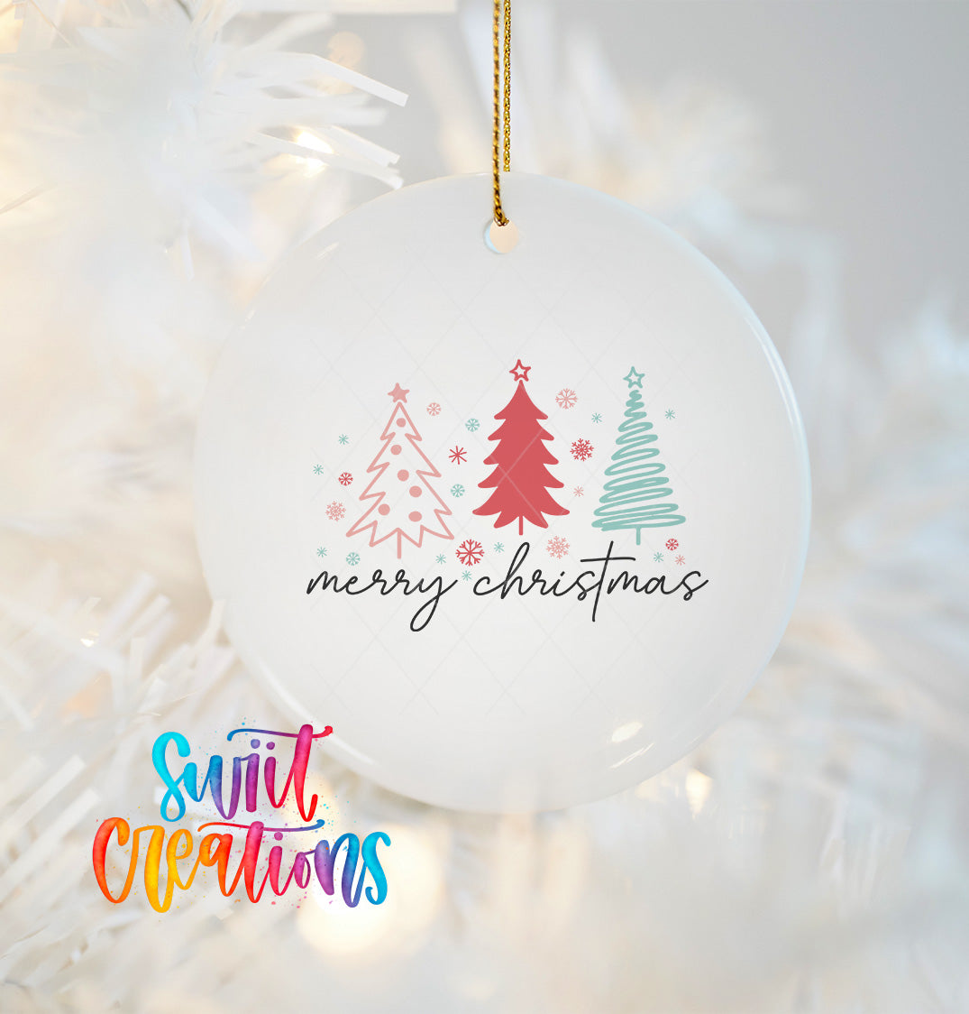 A white Christmas ornament with a festive design featuring three stylized Christmas trees and the text "merry christmas" hanging from a string.