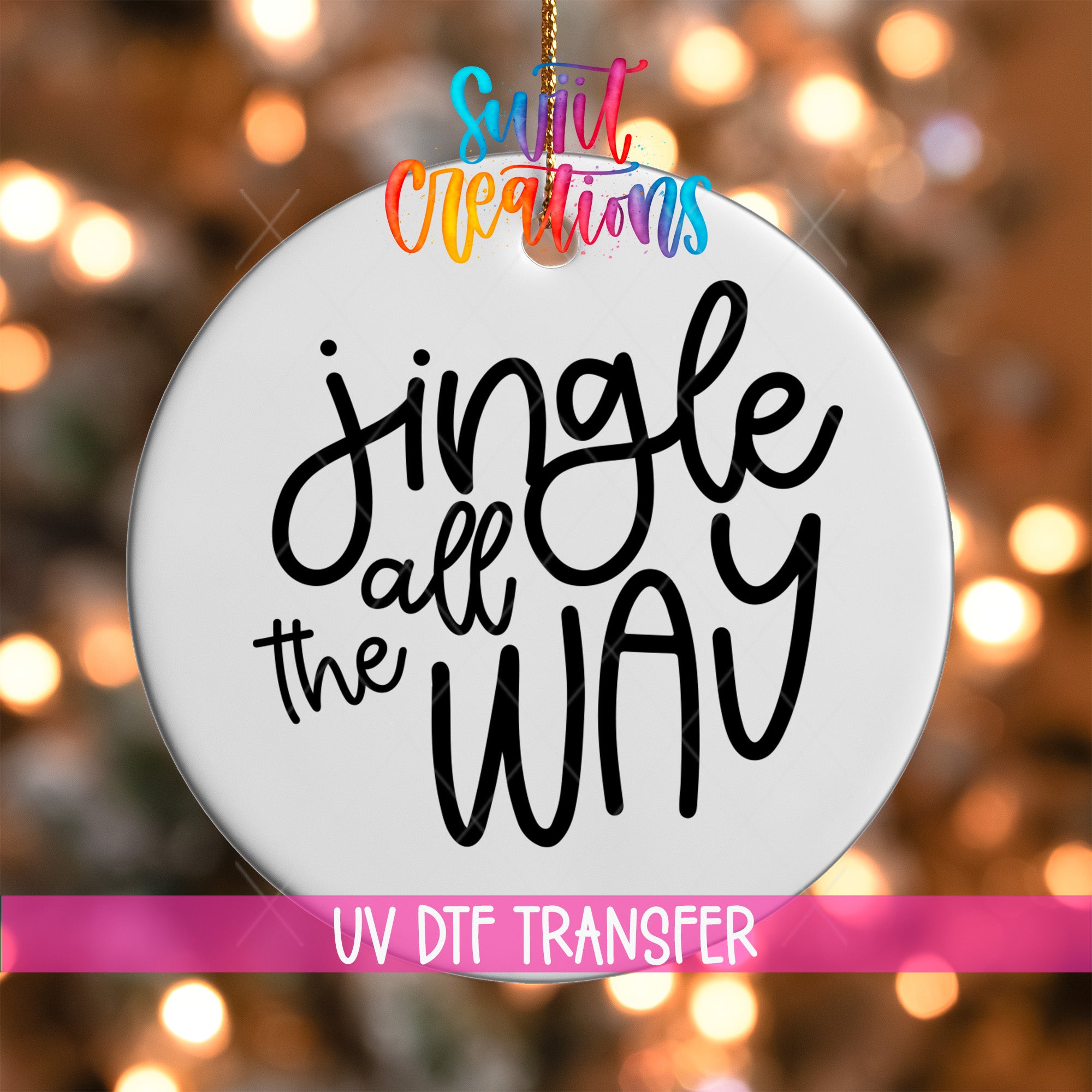 A white ornament with the text "Jingle all the way" written on it, hanging against a background of colorful lights.