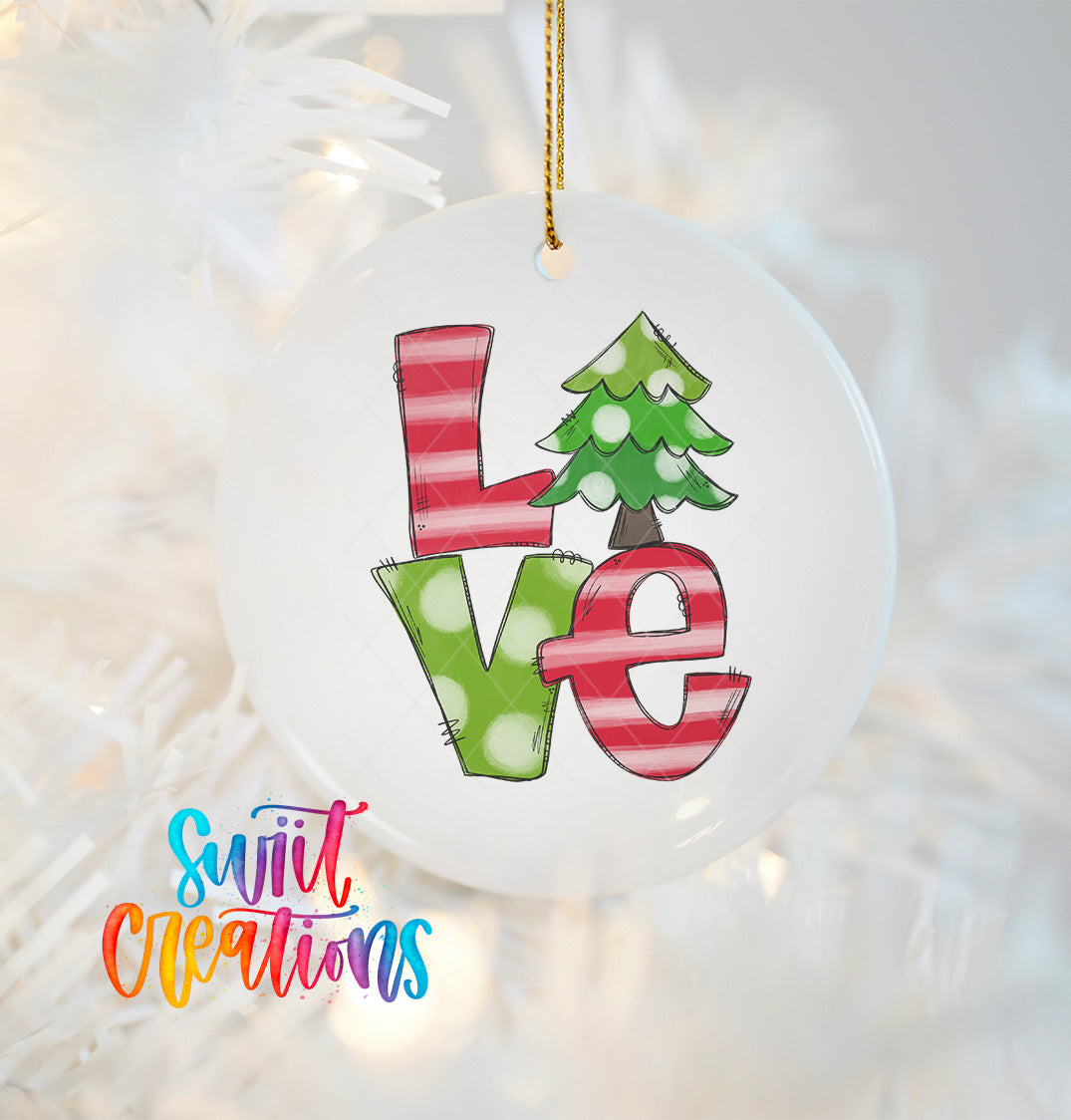 A white ornament with the word "Love" written in colorful letters, including a Christmas tree design.