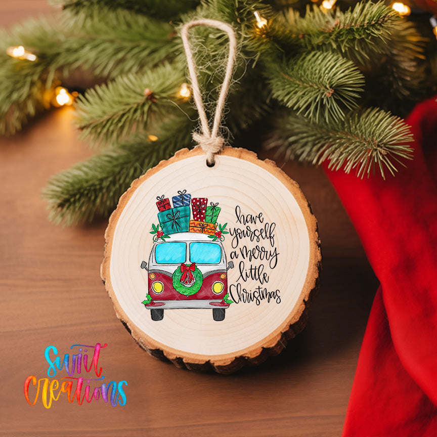 A wooden ornament with a red van and Christmas presents hanging on a Christmas tree.