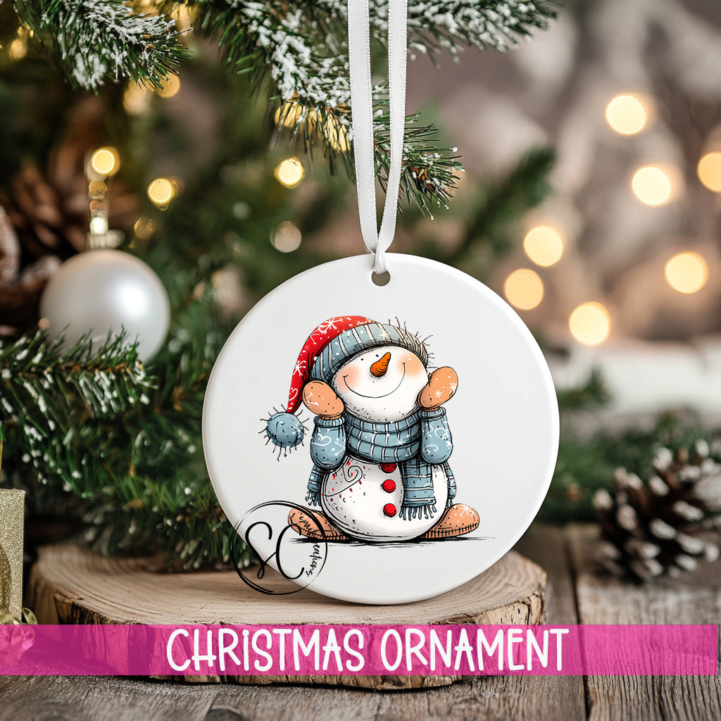 a snowman ornament hanging from a christmas tree