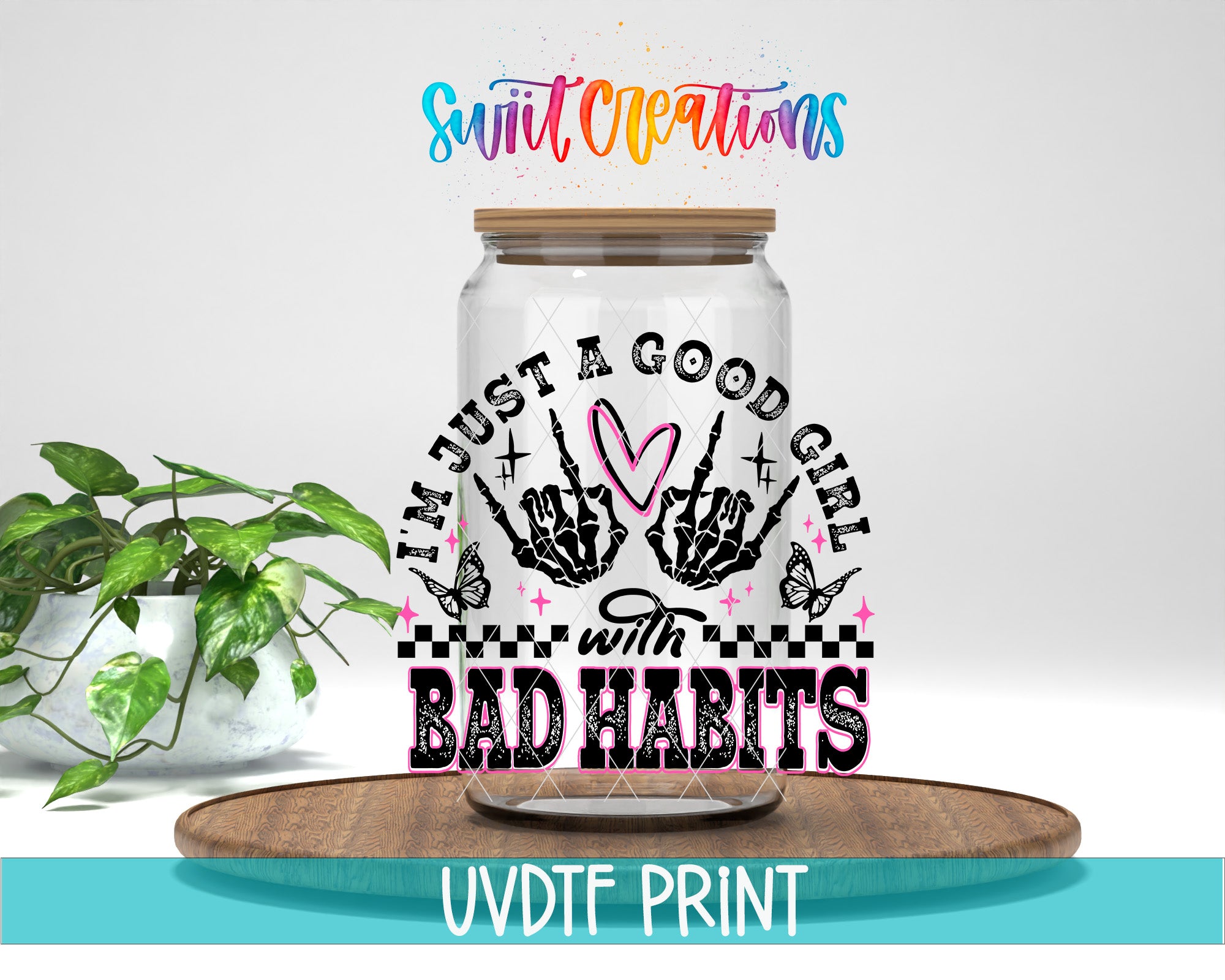 a glass jar with a hand-drawn design and text on it, placed on a wooden surface.