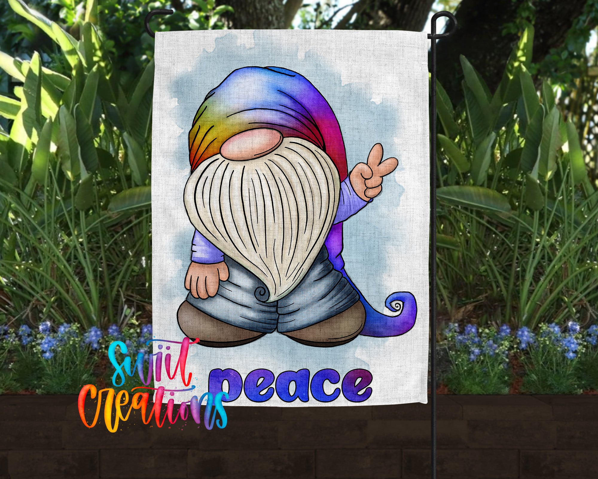 A colorful illustration of a gnome holding a peace sign, surrounded by greenery and flowers, with the text "still creations" and "peace" below the image.