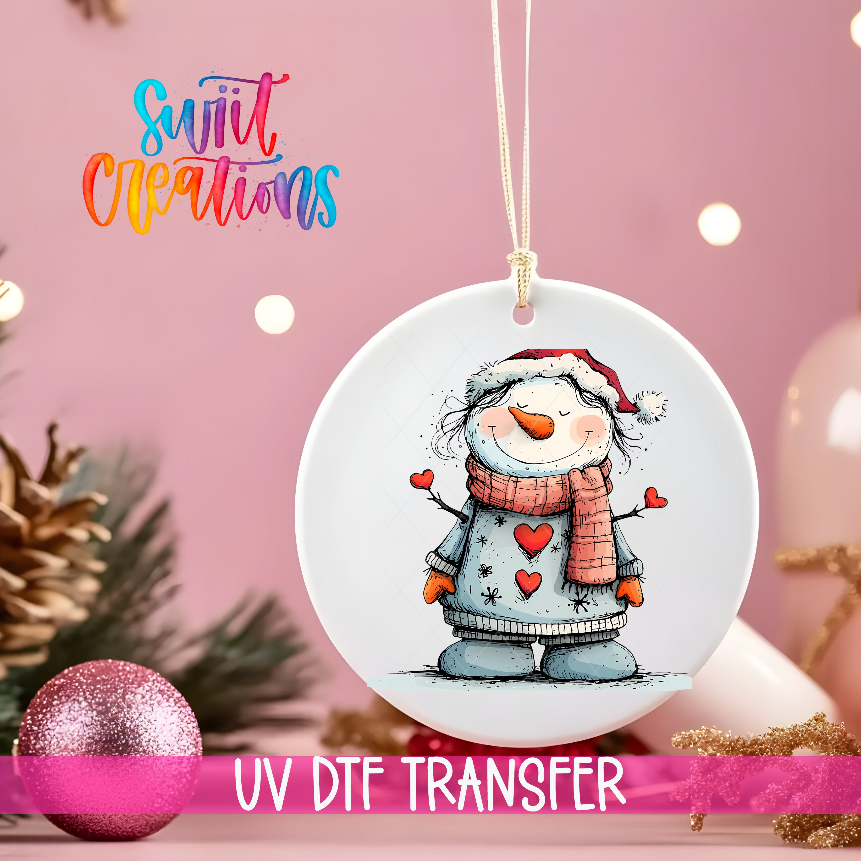 A white ceramic ornament with a snowman design, hanging on a string against a pink background.