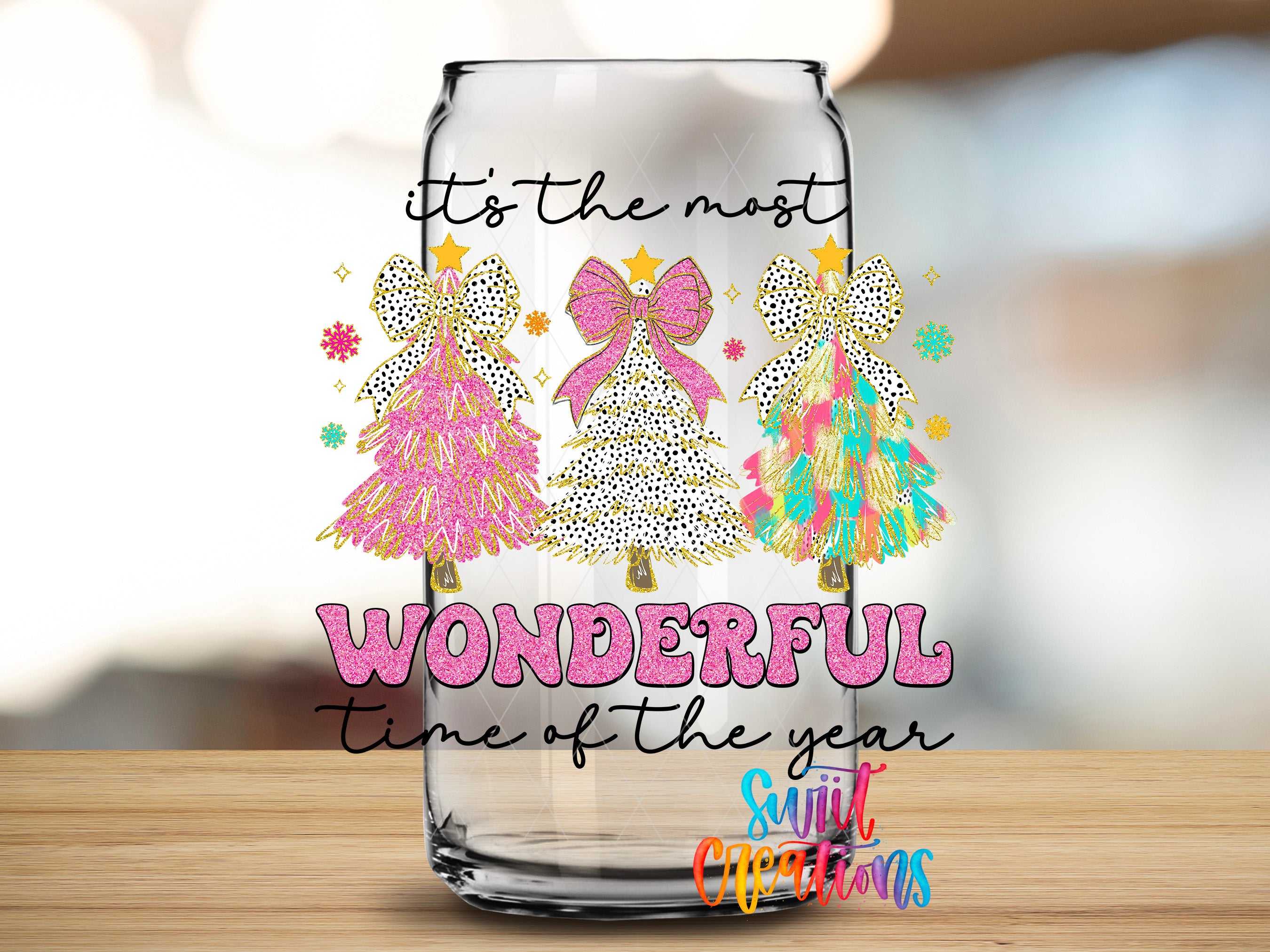 a glass jar with a festive design, including three Christmas trees and the text "It's the most WONDERFUL time of the year" written on it.