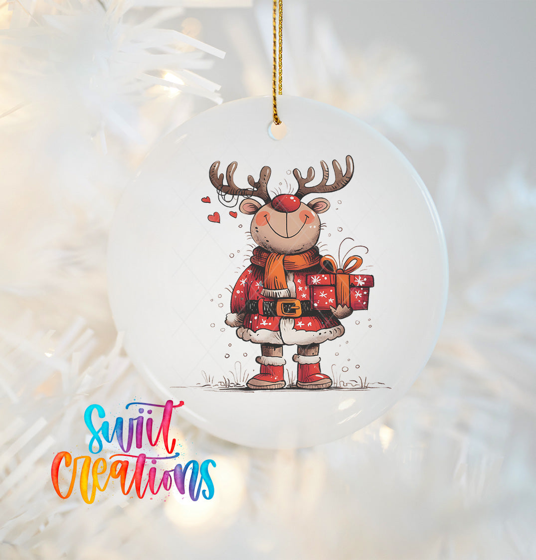 A white ornament featuring a cartoon reindeer holding a gift and wearing a red scarf.