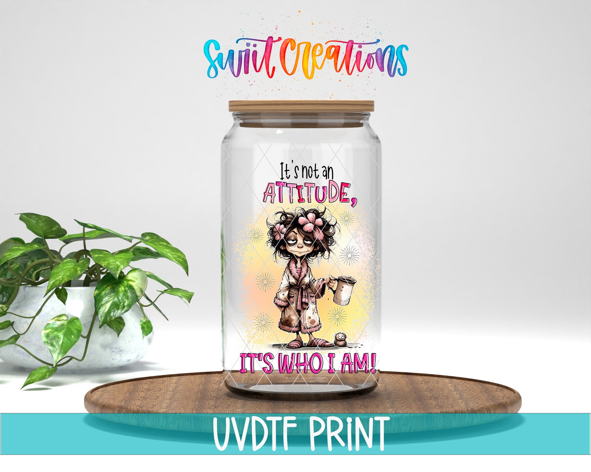 A glass jar with a cartoon character on it, placed on a wooden surface. The jar has a label that says "It's not an attitude, it's who I am!" The background is white, and there is a plant to the left of the jar.