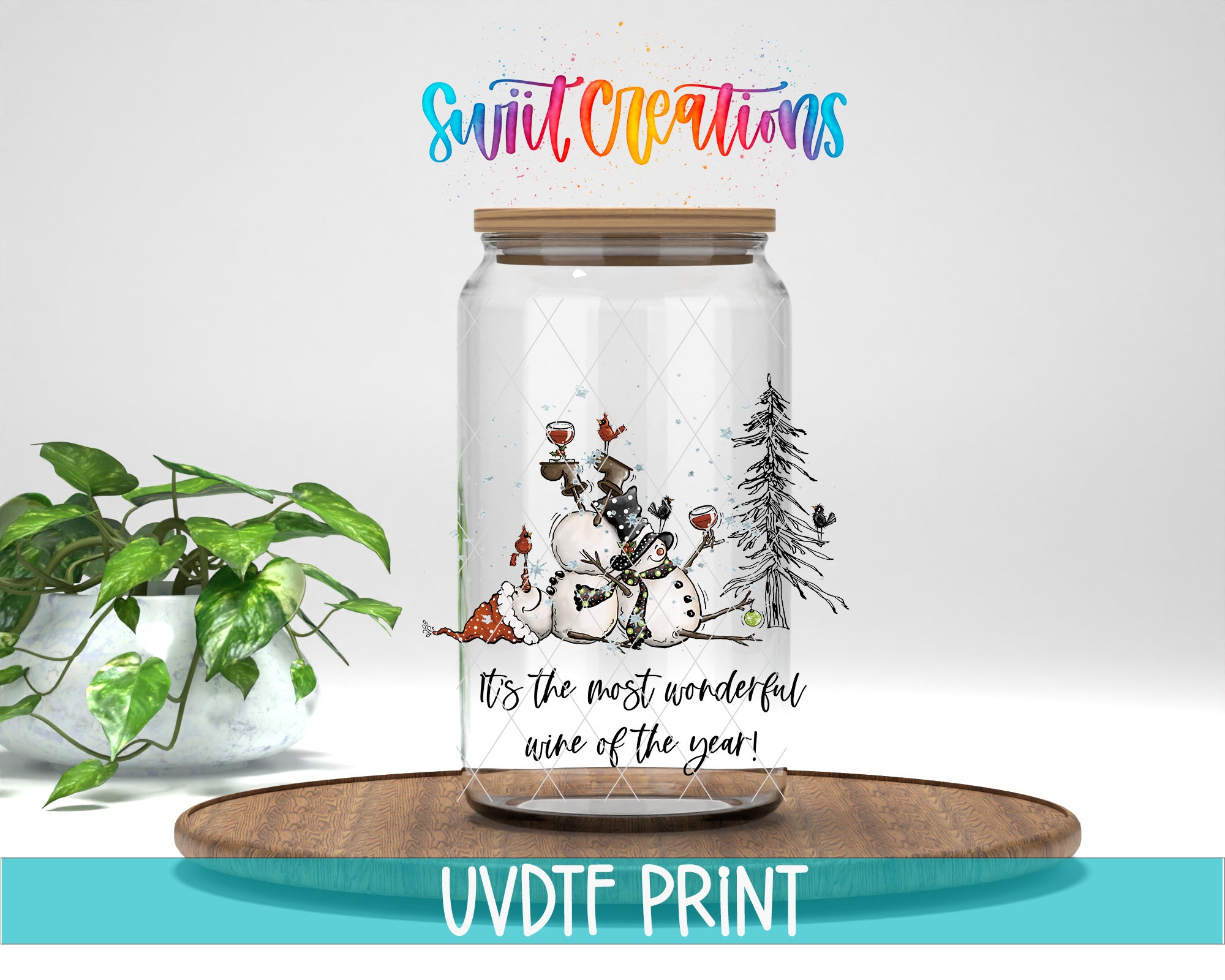 A glass jar with a snowman and pine tree illustration, placed on a wooden surface. The jar has a label that says "It's the most wonderful wine of the year!" and there is a colorful text above it that says "Swift Creations".