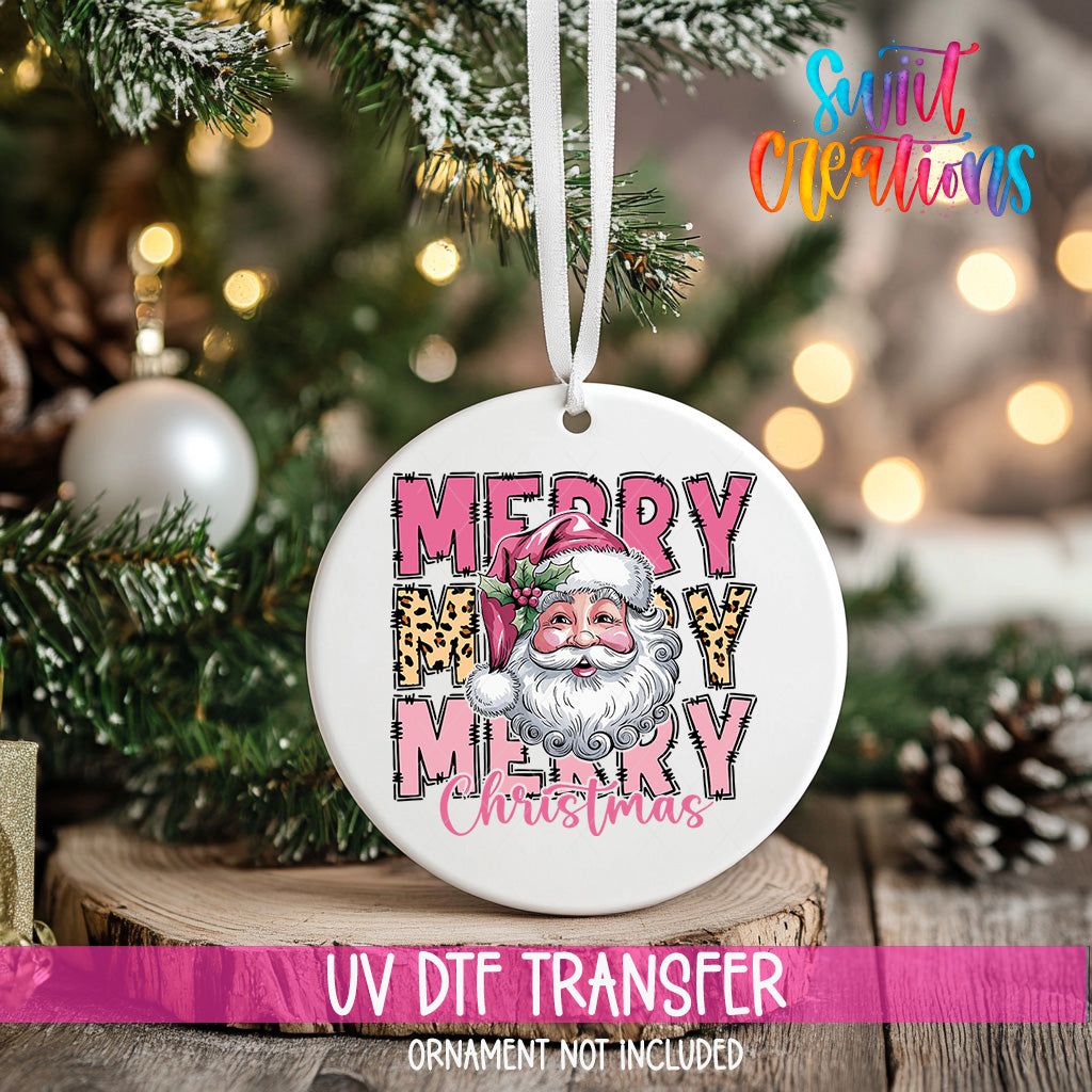 A white ceramic ornament with a Santa Claus image and the text "MERRY MARY CHRISTMAS" is hanging on a Christmas tree.