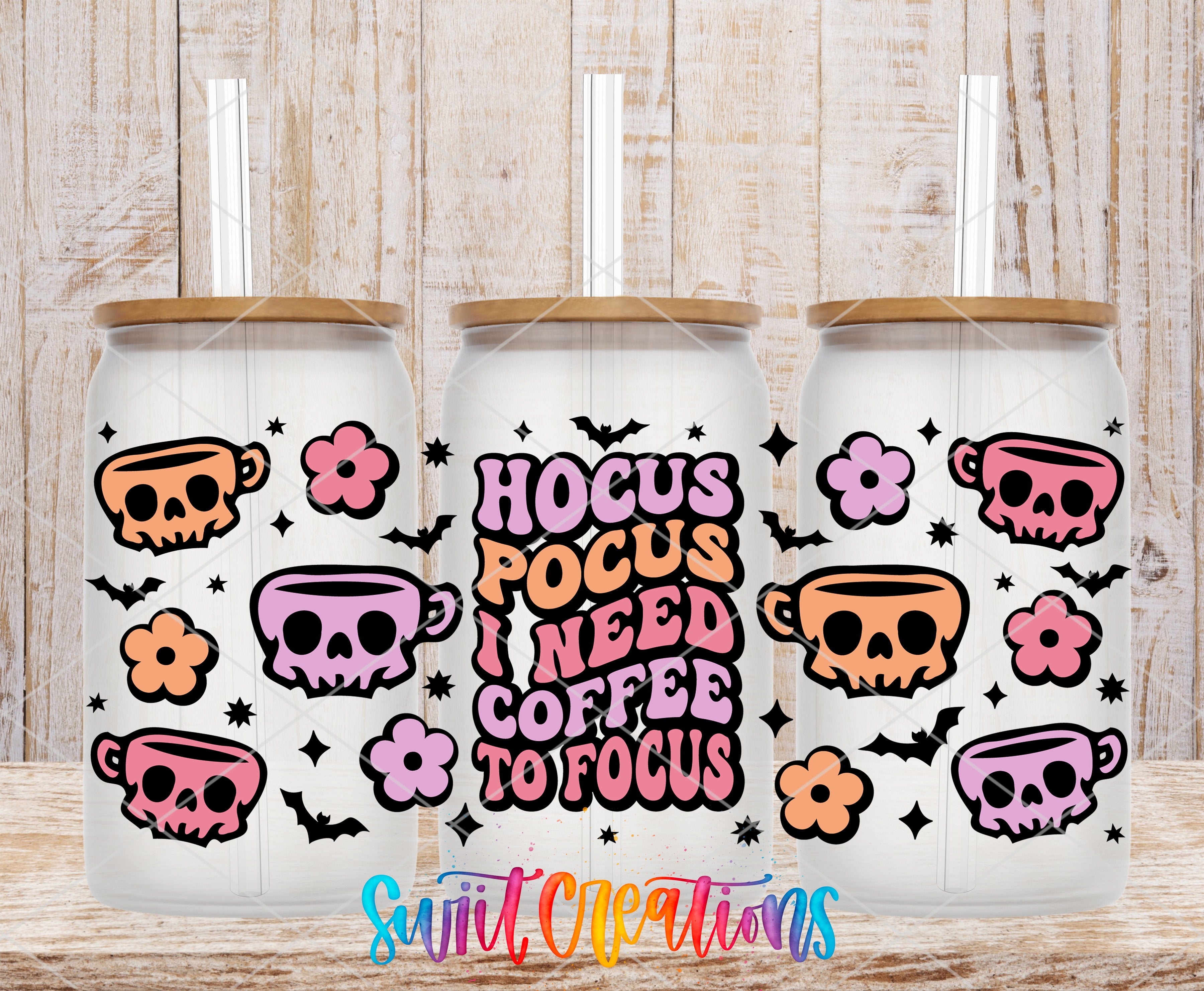three white tumblers with colorful designs and text on them, placed on a wooden surface.