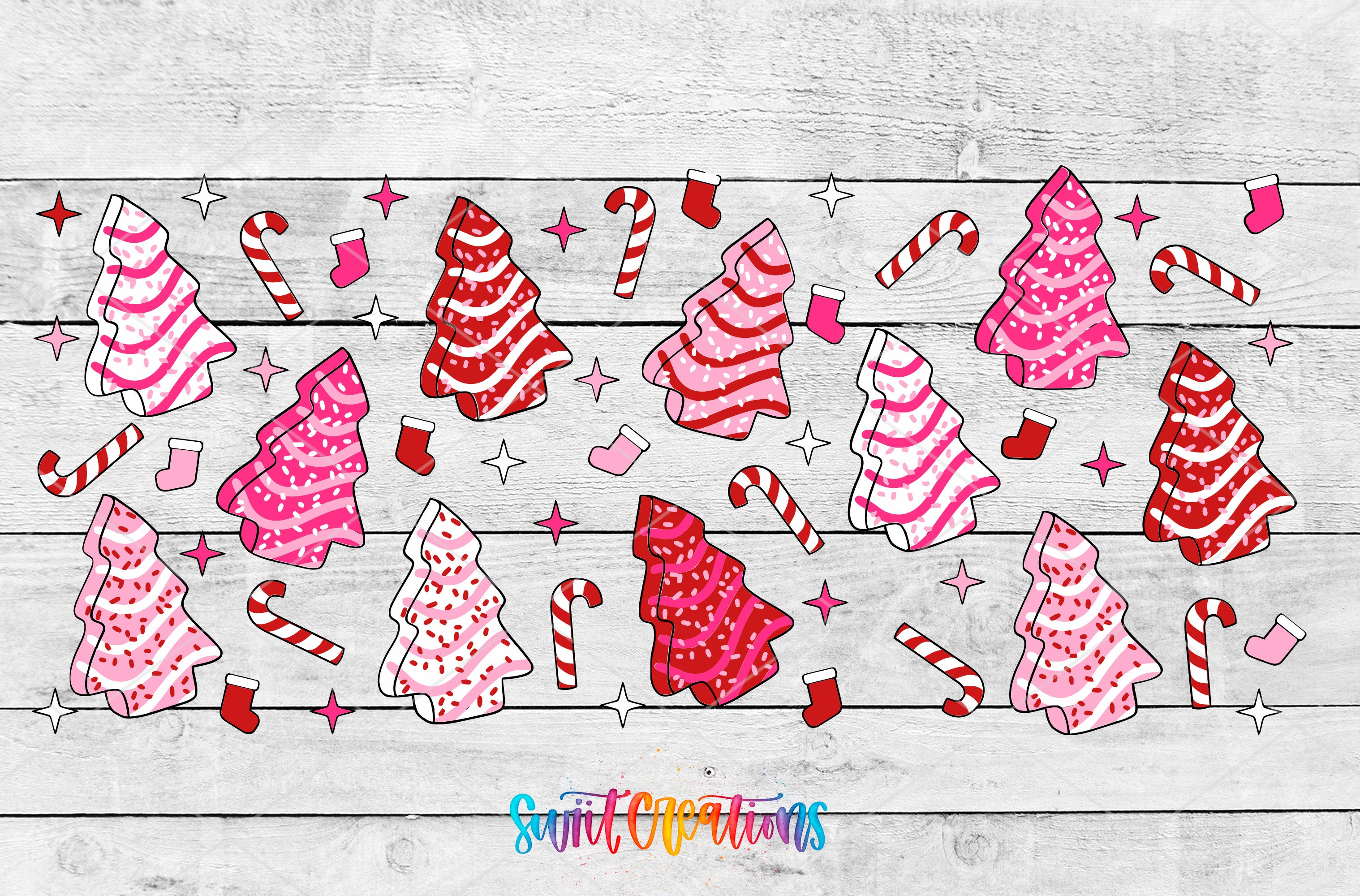 A festive arrangement of pink and red Christmas trees, candy canes, and other holiday decorations on a wooden background.