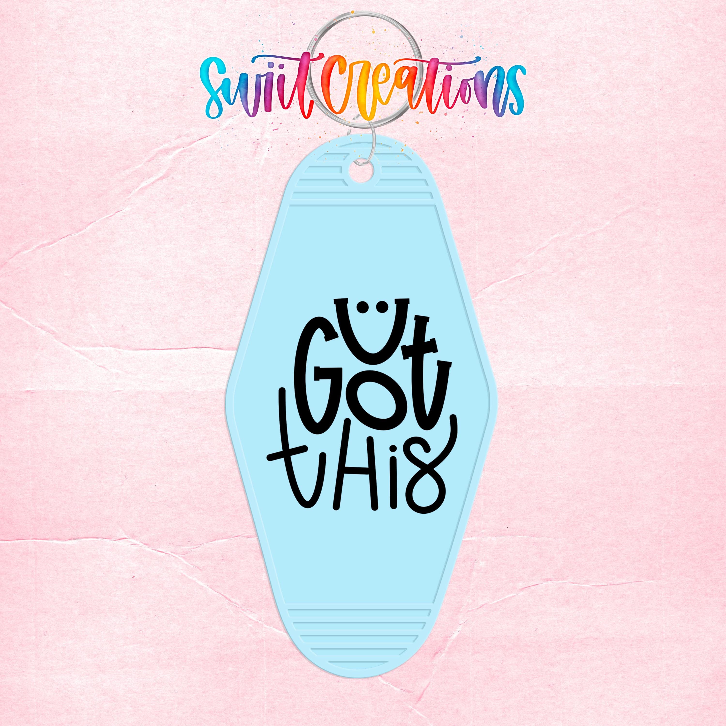A keychain with the text "Got this" printed on it, set against a pink background.