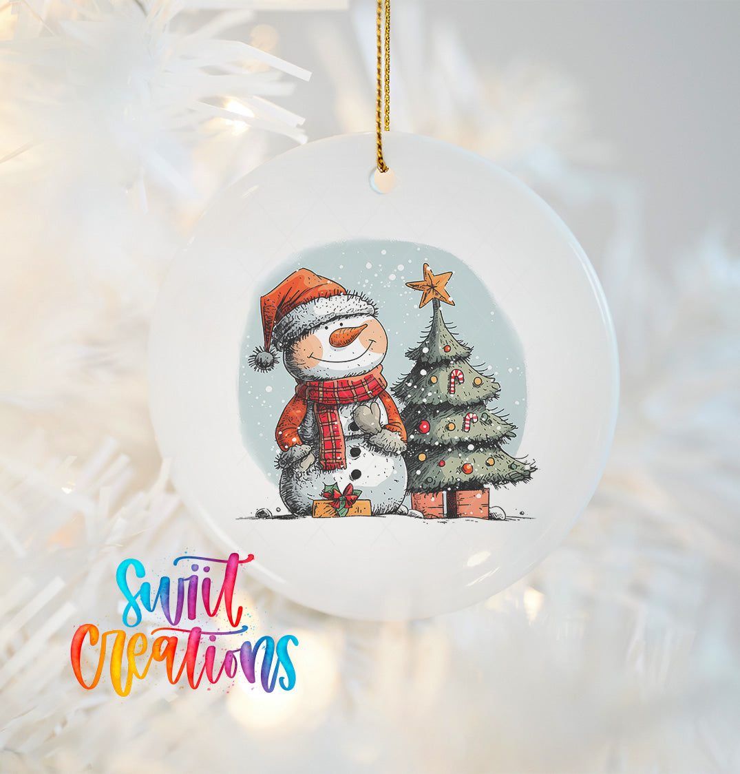 A white Christmas ornament featuring a snowman and a decorated Christmas tree.