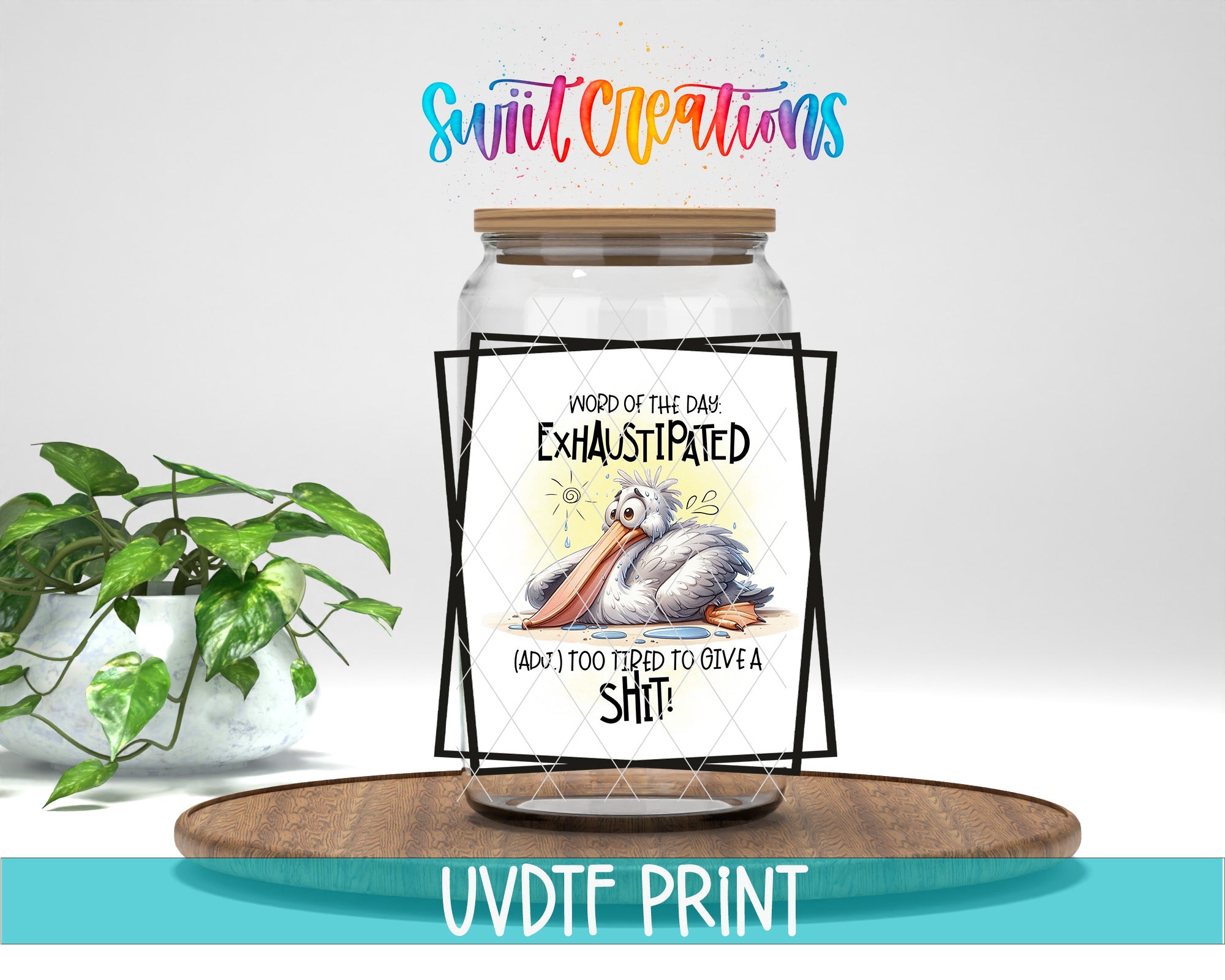 a glass jar with a humorous text and drawing on it, placed on a wooden surface next to a potted plant.