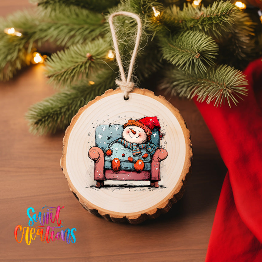 A wooden ornament with a snowman sitting in a chair, surrounded by Christmas lights and greenery.