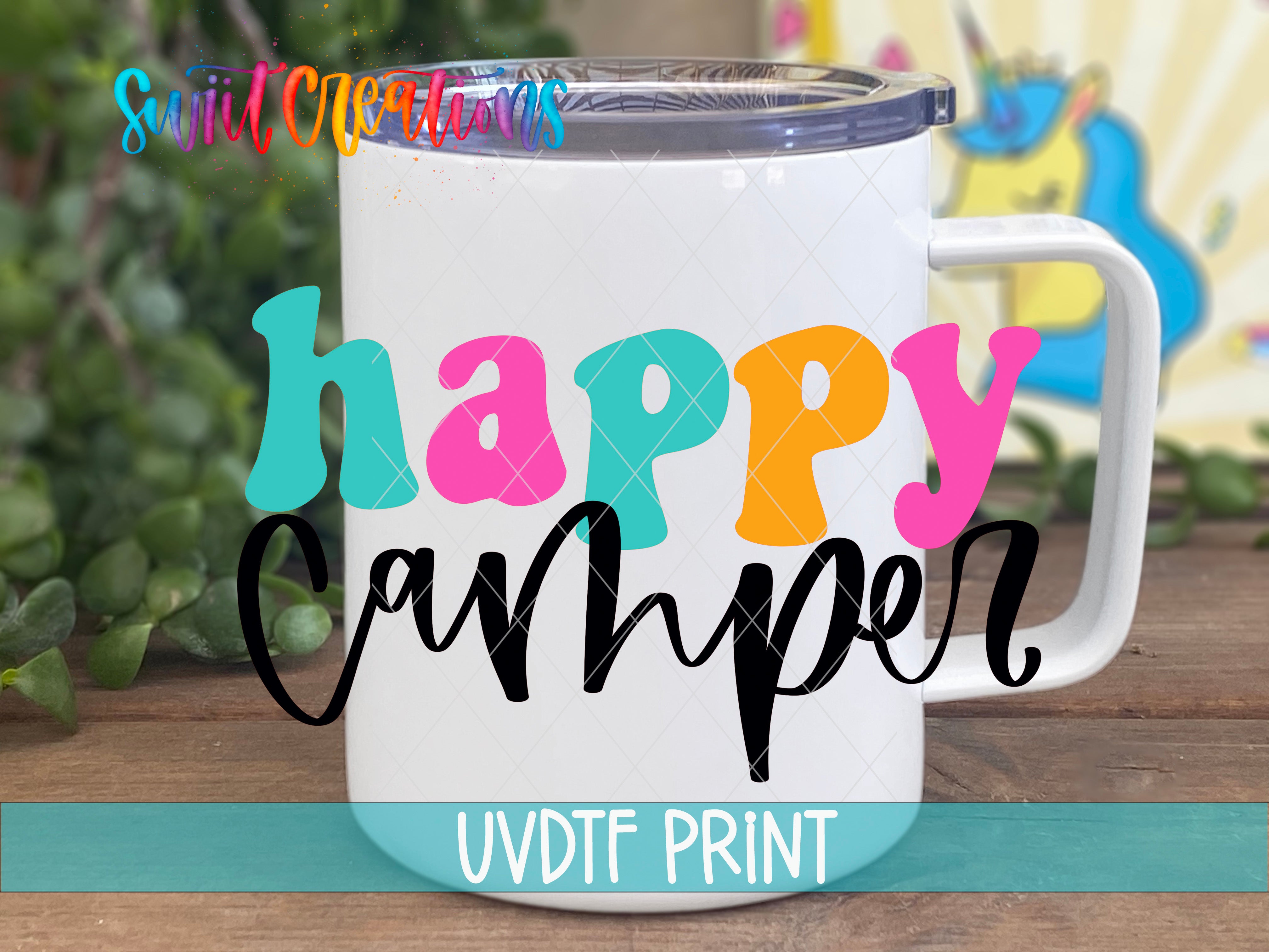 A white insulated mug with a colorful text design on it, placed on a wooden surface.