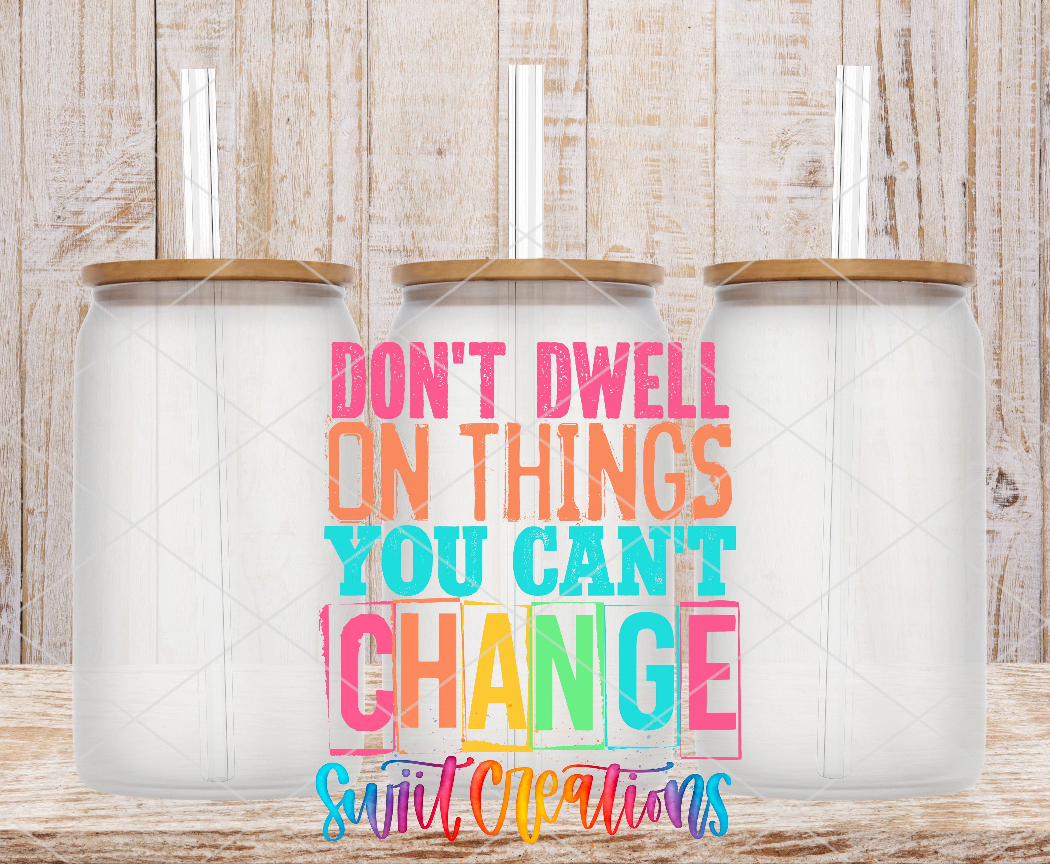 Swiit Creations UV DTF Don’t Dwell on What You Cannot Change transfer shown on a clear glass can set