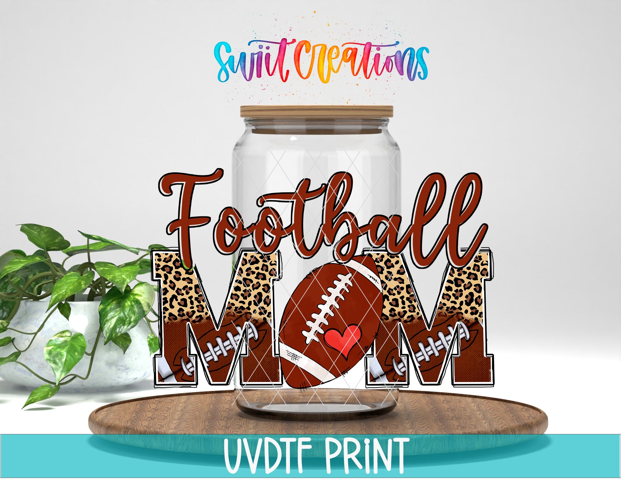 A glass jar with a leopard print design and a football graphic inside, along with the text "Football Mom" written on it. The jar is placed on a wooden surface, and there is a plant in the background.
