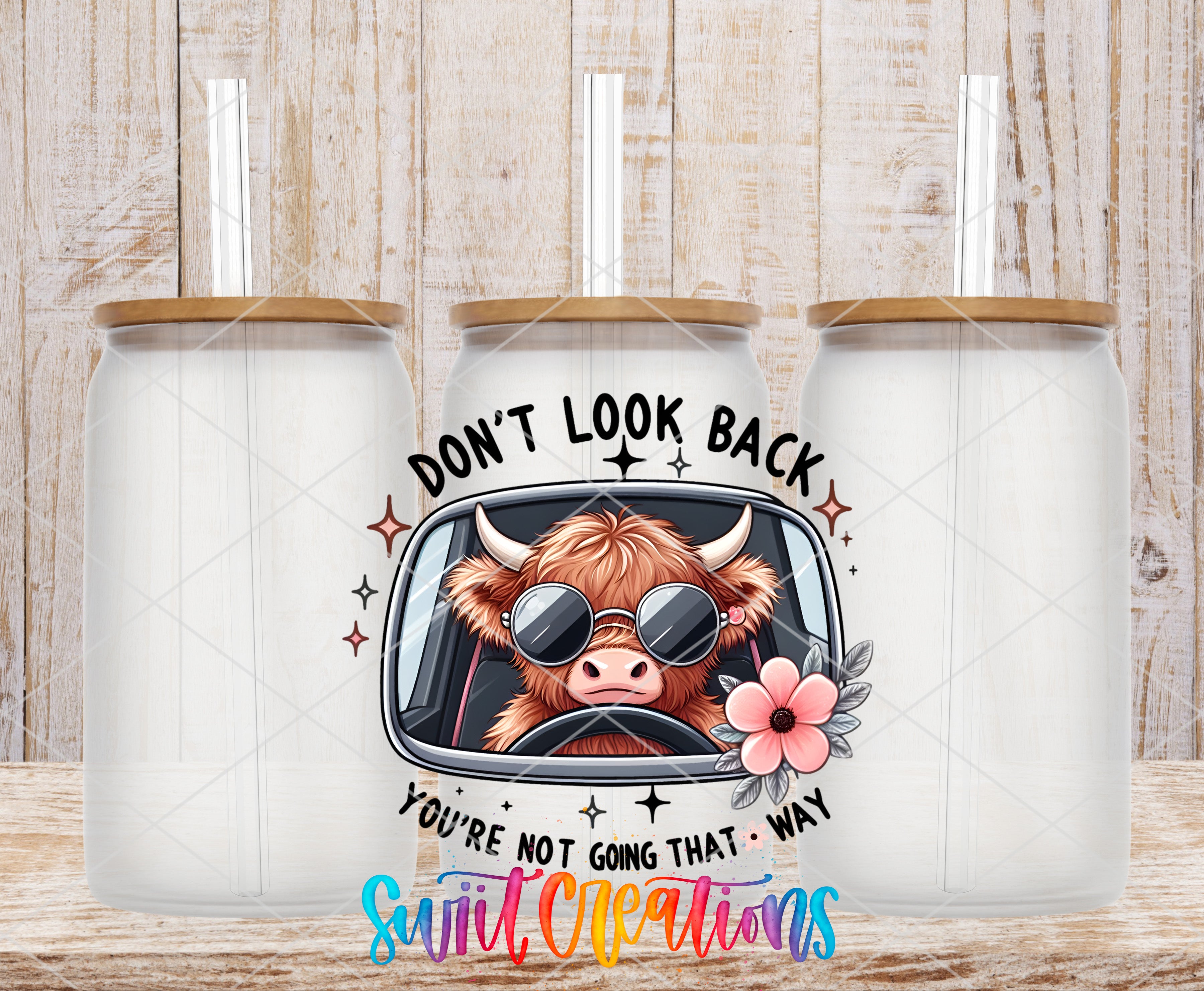 Swiit Creations UV DTF Don't Look Back Cow transfer shown on a clear glass can set