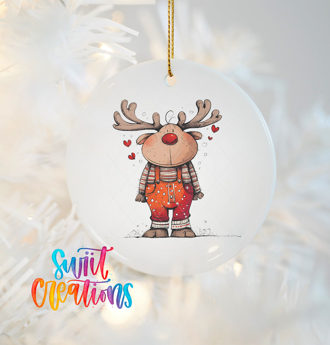 A white ornament featuring a cartoon reindeer with antlers and hearts, hanging on a Christmas tree.