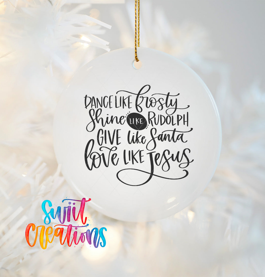 a white ornament with a black text message that reads "Dance like Frosty, shine like Rudolph, give like Santa, love like Jesus".