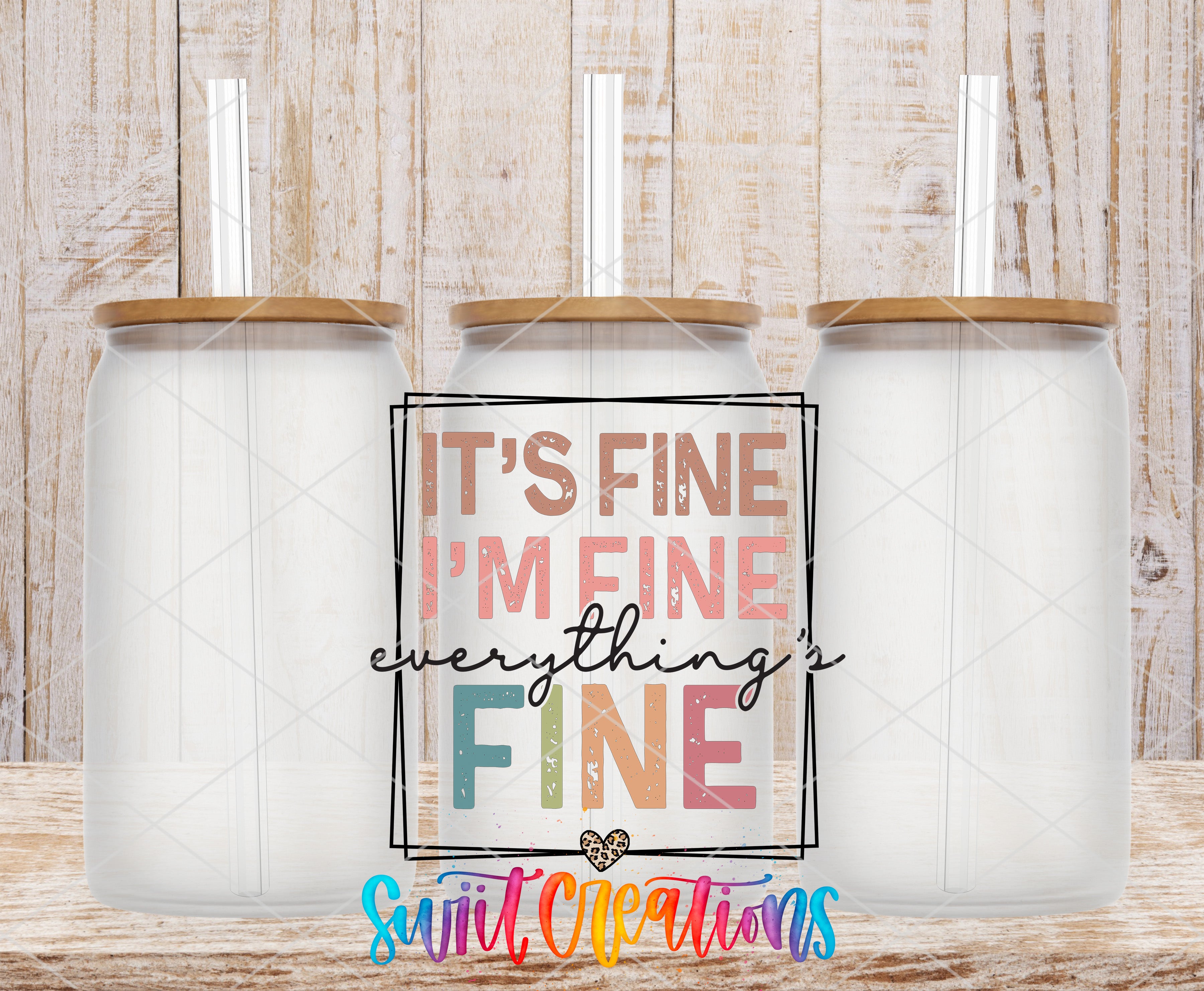 Swiit Creations UV DTF It's Fine I'm Fine Everything is Fine transfer shown on a clear glass can set