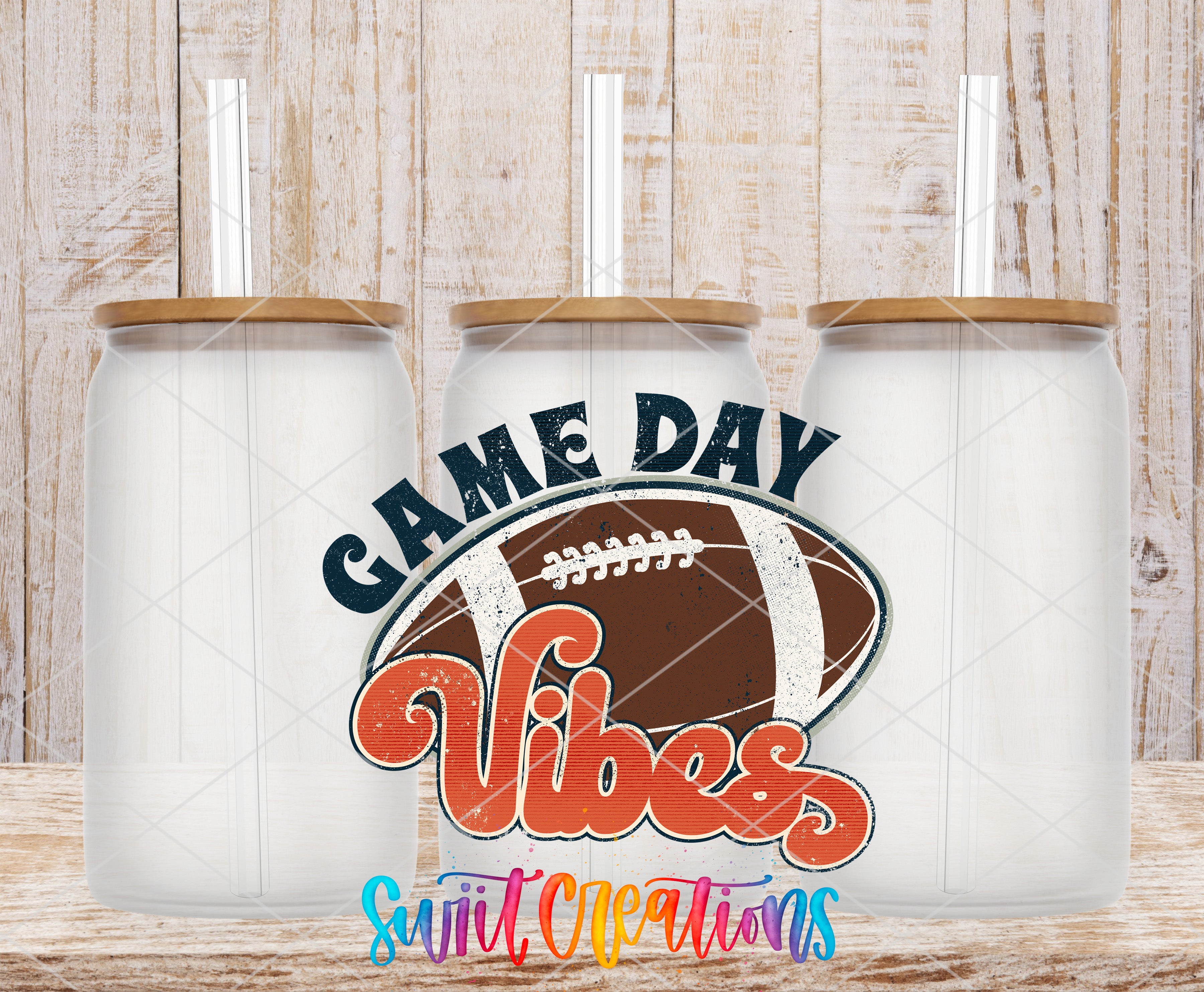 Three clear glass cans with the Football Game Day Vibes UV DTF transfer by Swiit Creations