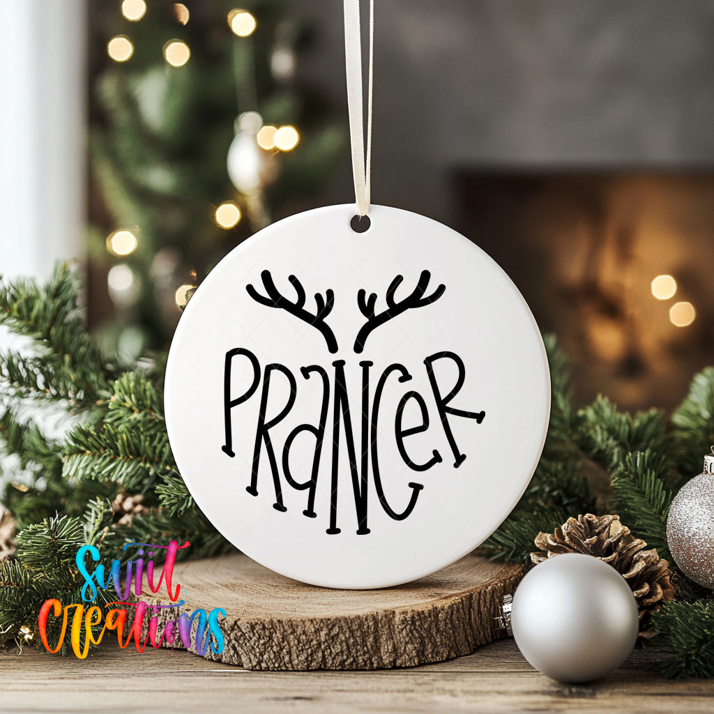 A white ornament with the word "PRANNER" written on it, hanging from a string, surrounded by Christmas decorations such as pine branches and ornaments.